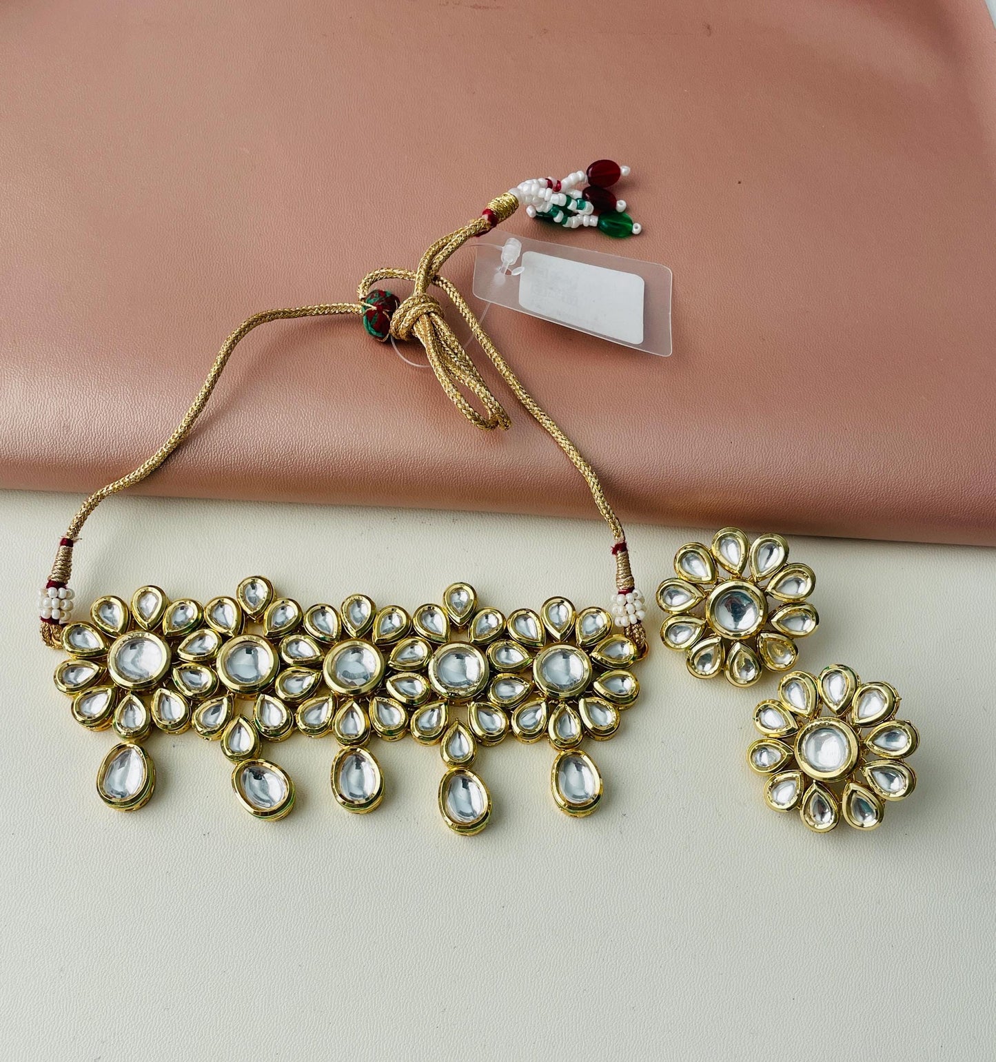 Kundan gold plated choker with matching earring . This big floral designis very unique and instead of dangles it comes with big flower studs