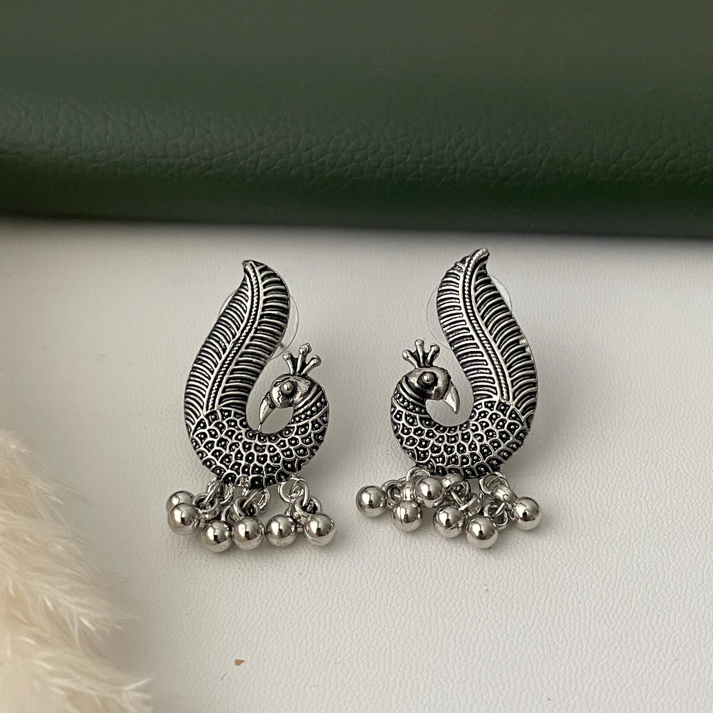 Oxidized earrings in peacock motifs.