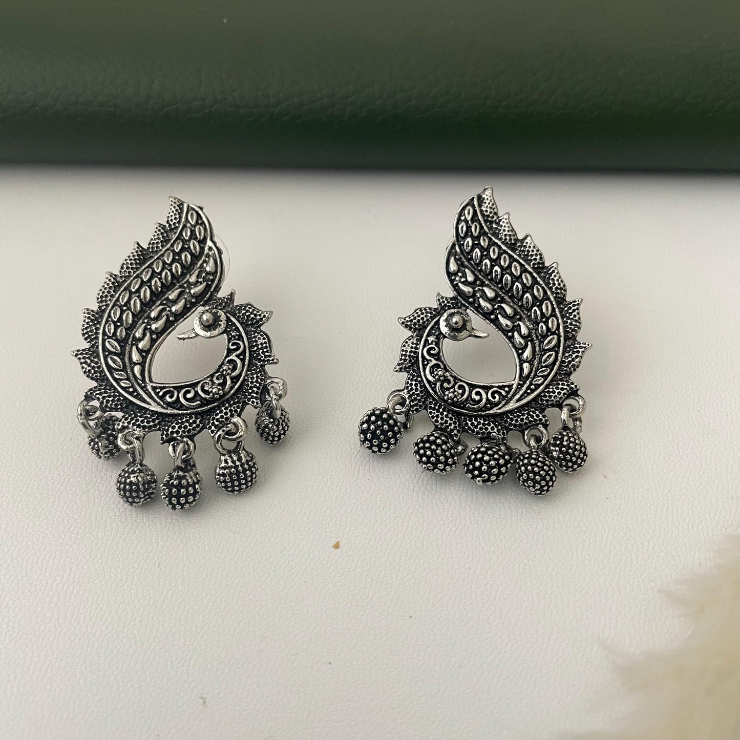 Oxidized earrings in peacock motifs.