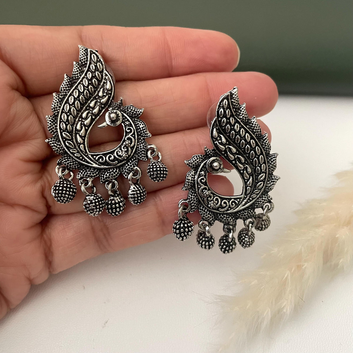 Oxidized earrings in peacock motifs.