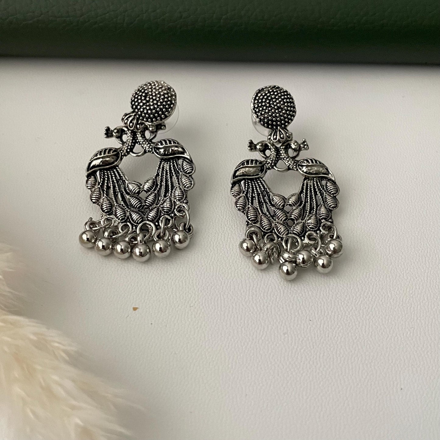Oxidized earrings in peacock motifs.
