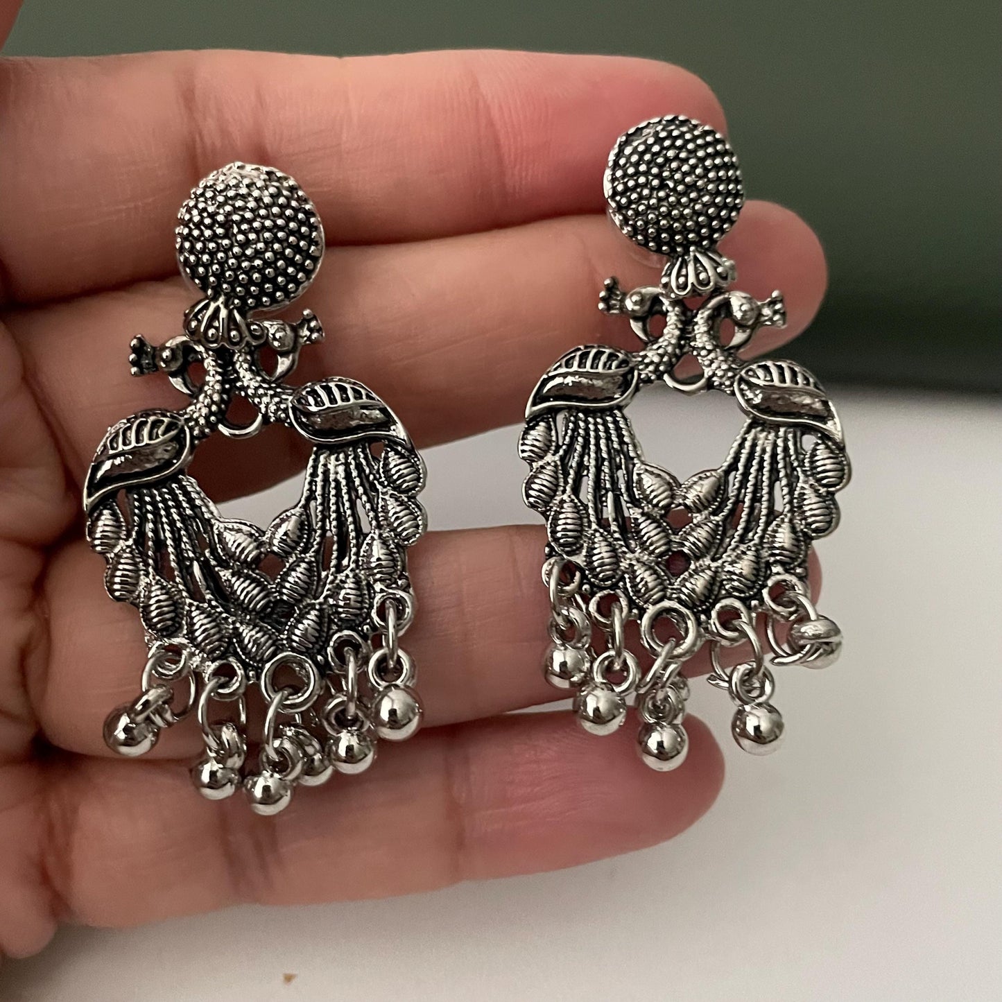 Oxidized earrings in peacock motifs.
