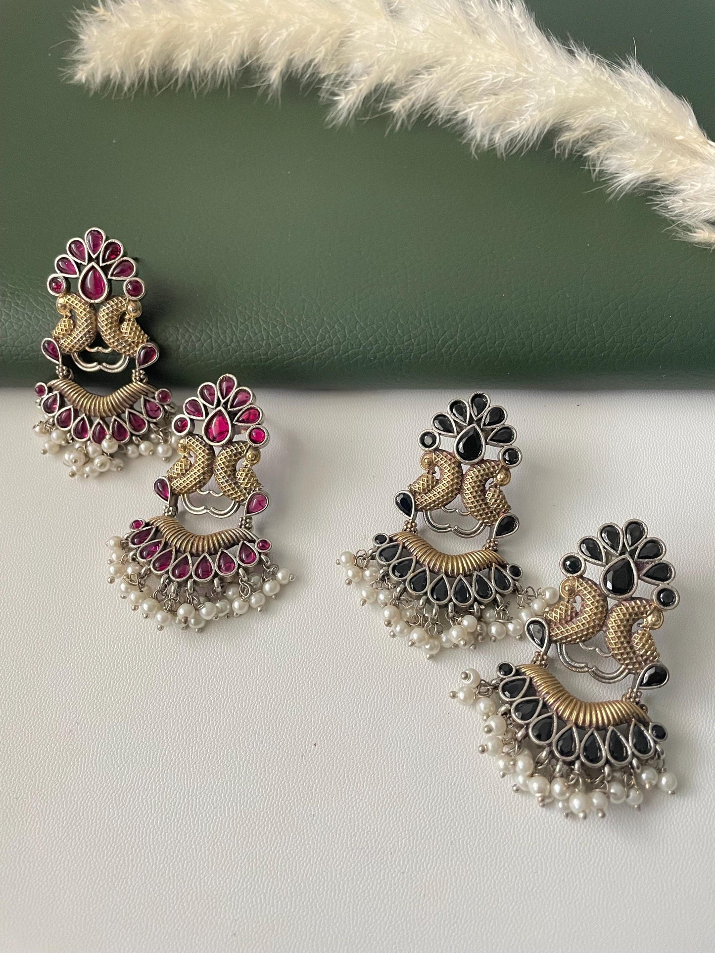 Oxidised dual tone peacock motif earrings