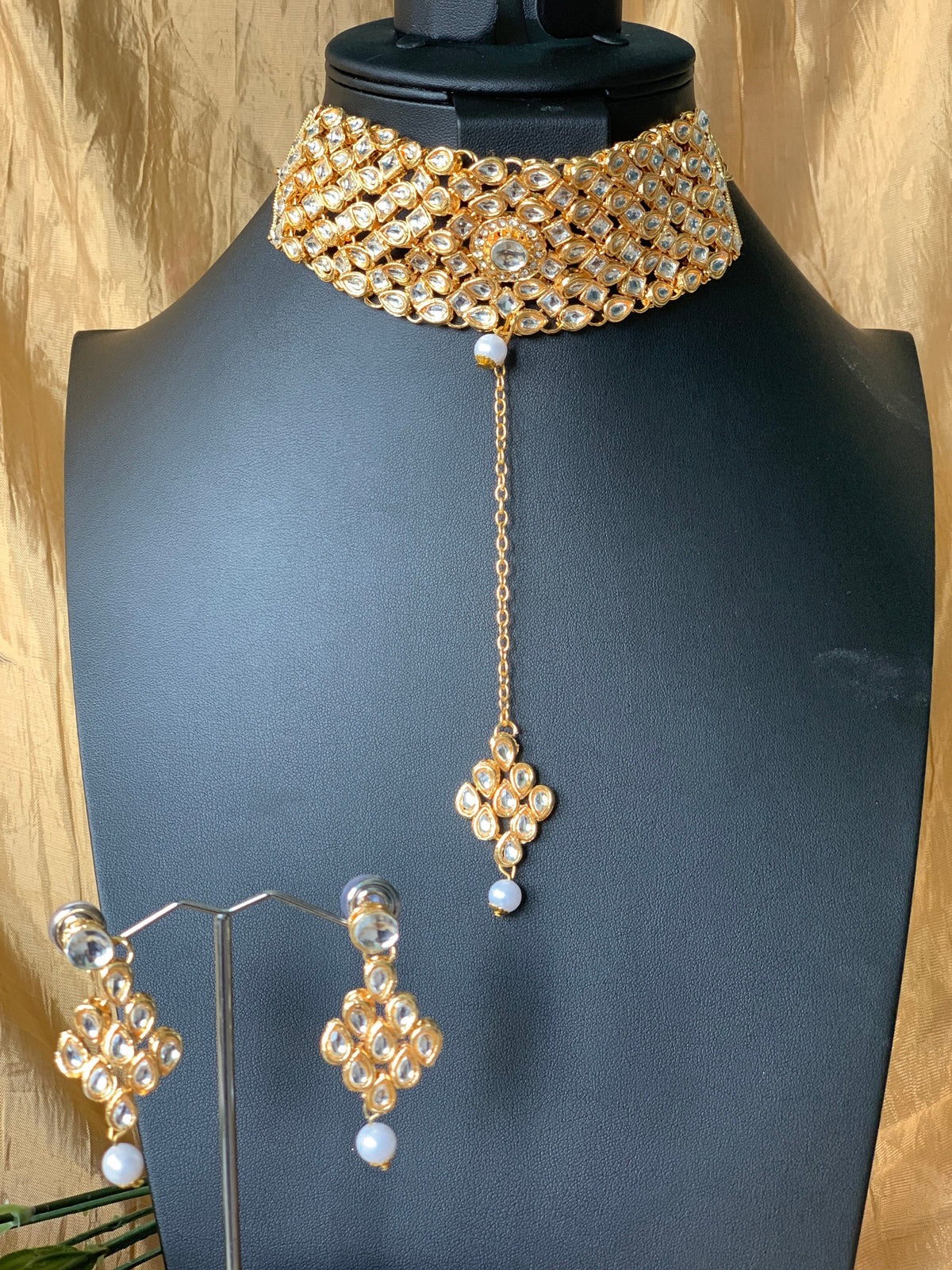 Gold plated kundan choker set with earrings and Maang tikka