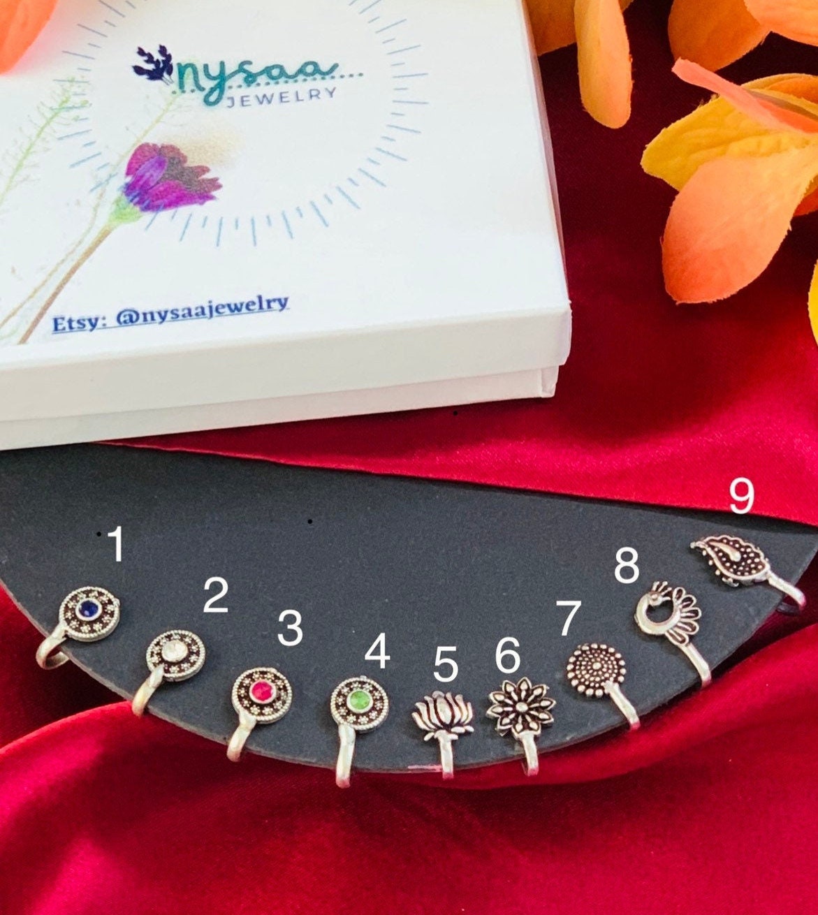 Oxidised nose pins . Perfect for garba season . lots of color and designs available. black, red , white , green , plain , peacock shaped nose pin . clip on nose pins