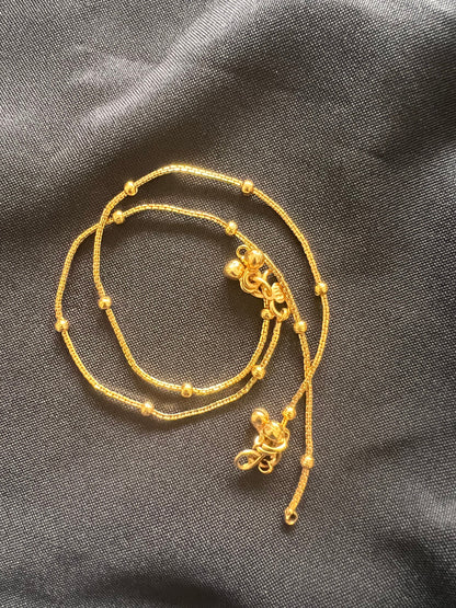 A gold chain anklet with small round beads and two decorative clasps. High gold plated anklets comes in a pair