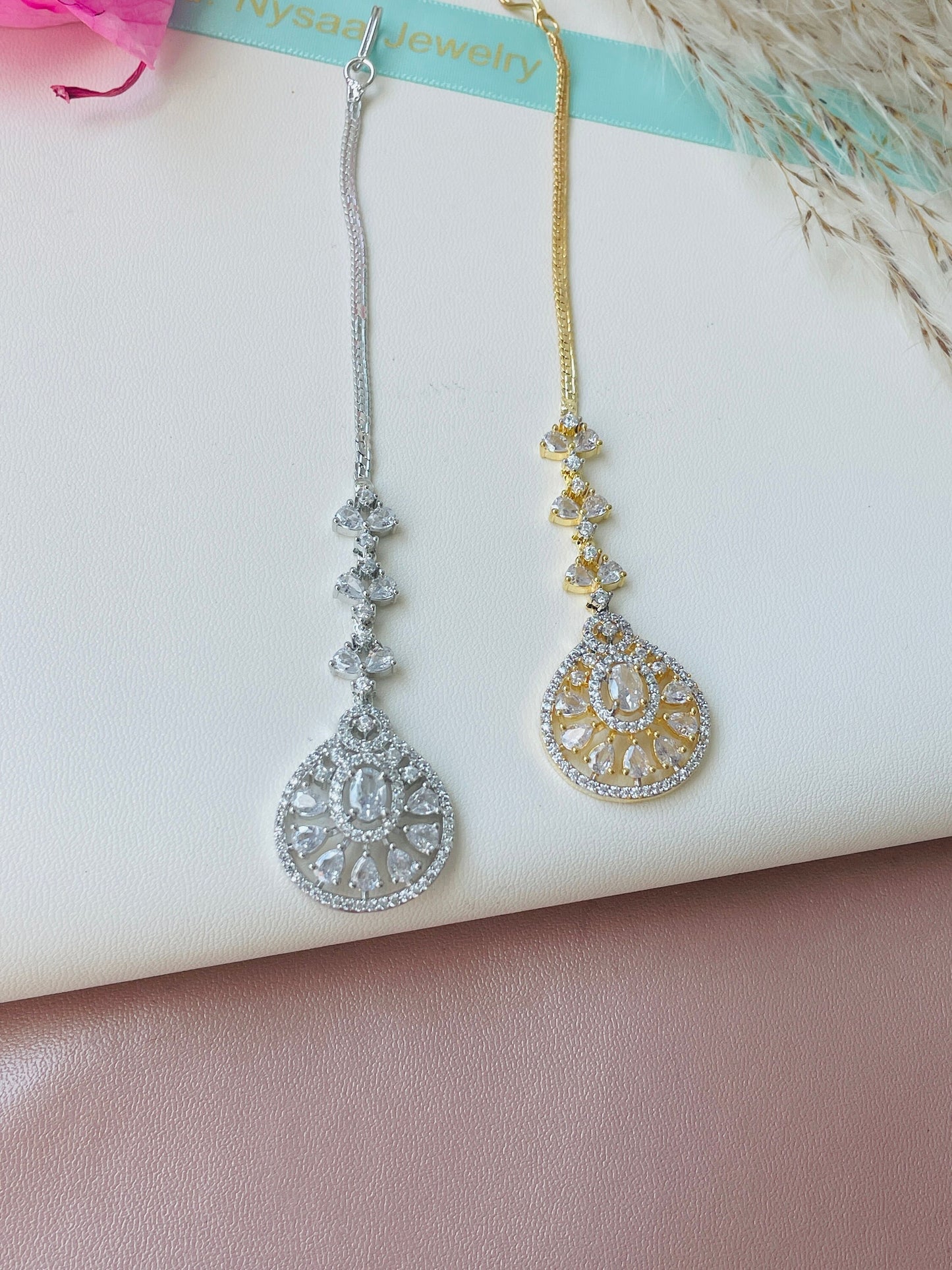 Cubic Zirconia gold plated Maang tikka . Studded with American diamonds or cubic zirconia gems. Silver rhodium plated and two toned options available. 7” in length