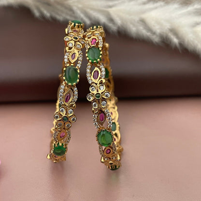Green , Ruby and cubic zirconia bangles in beautifully carved flower n leaf design. Gold plated . Size 2.8