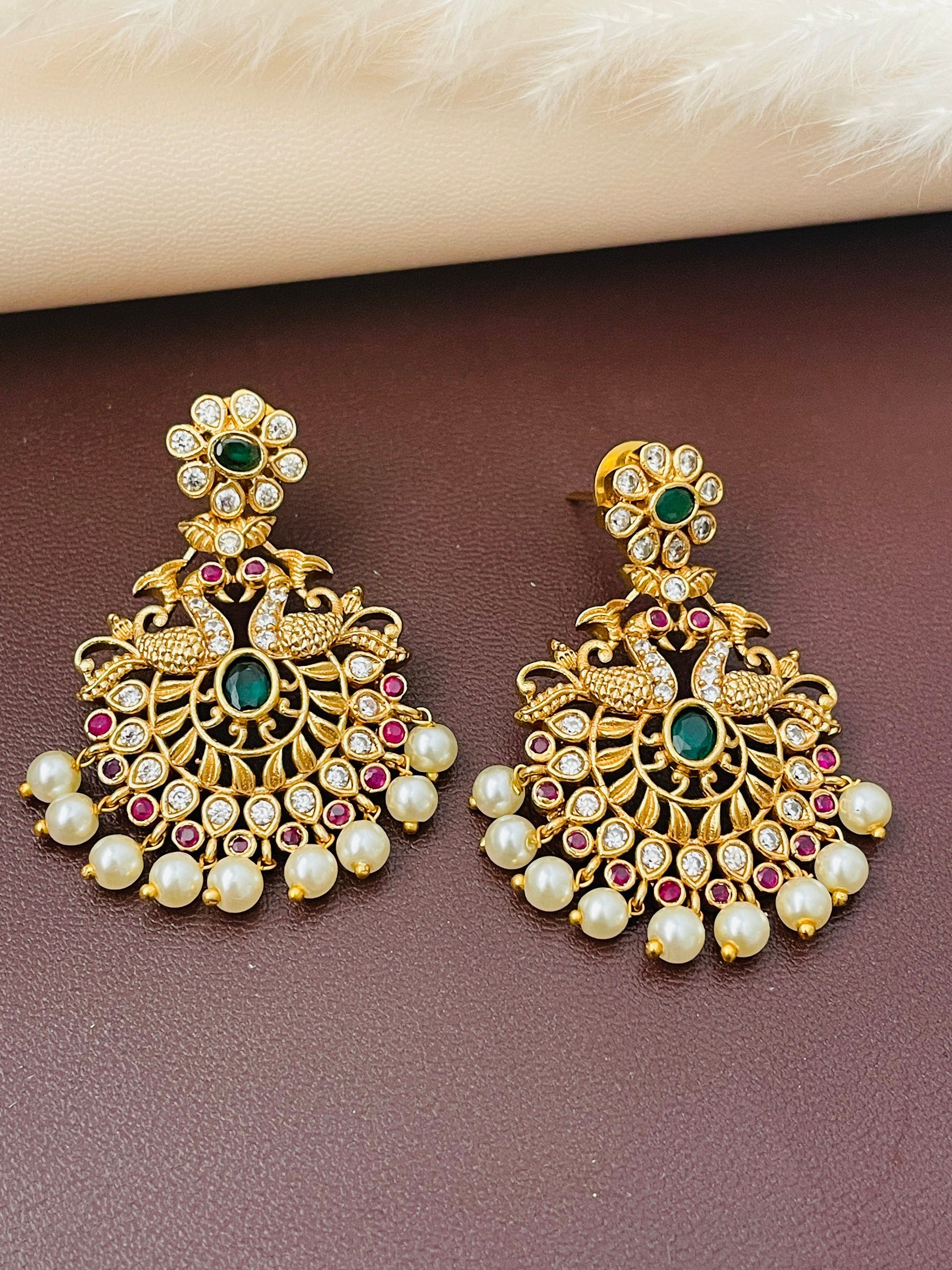 Gold plated kemp stone , ad, pearl earringswith peacock and flower motif . 1.5 inches long . Indian temple earrings