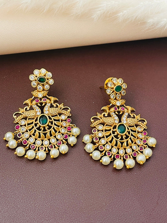 Gold plated kemp stone , ad, pearl earringswith peacock and flower motif . 1.5 inches long . Indian temple earrings