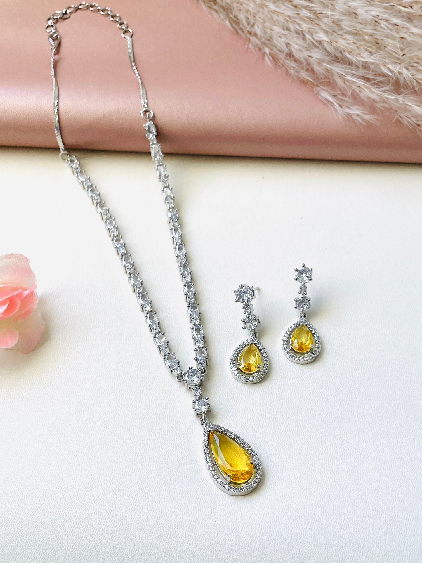 ADcubi zirconia Deepika Padukone necklace set . It’s white AD necklace with either amber or royal blue pendant with matching earrings.