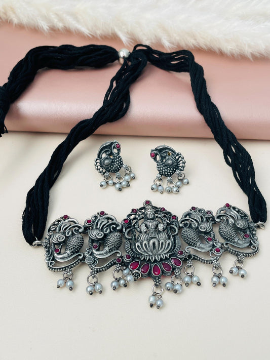 Oxidised temple jewelry with Lakshmiji detailing. Comes with matching cute peacock earrings.