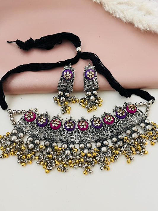 Dual tone Oxidised ghungaroo choker with multiple color option . Comes with matching earrings . Adjustable length