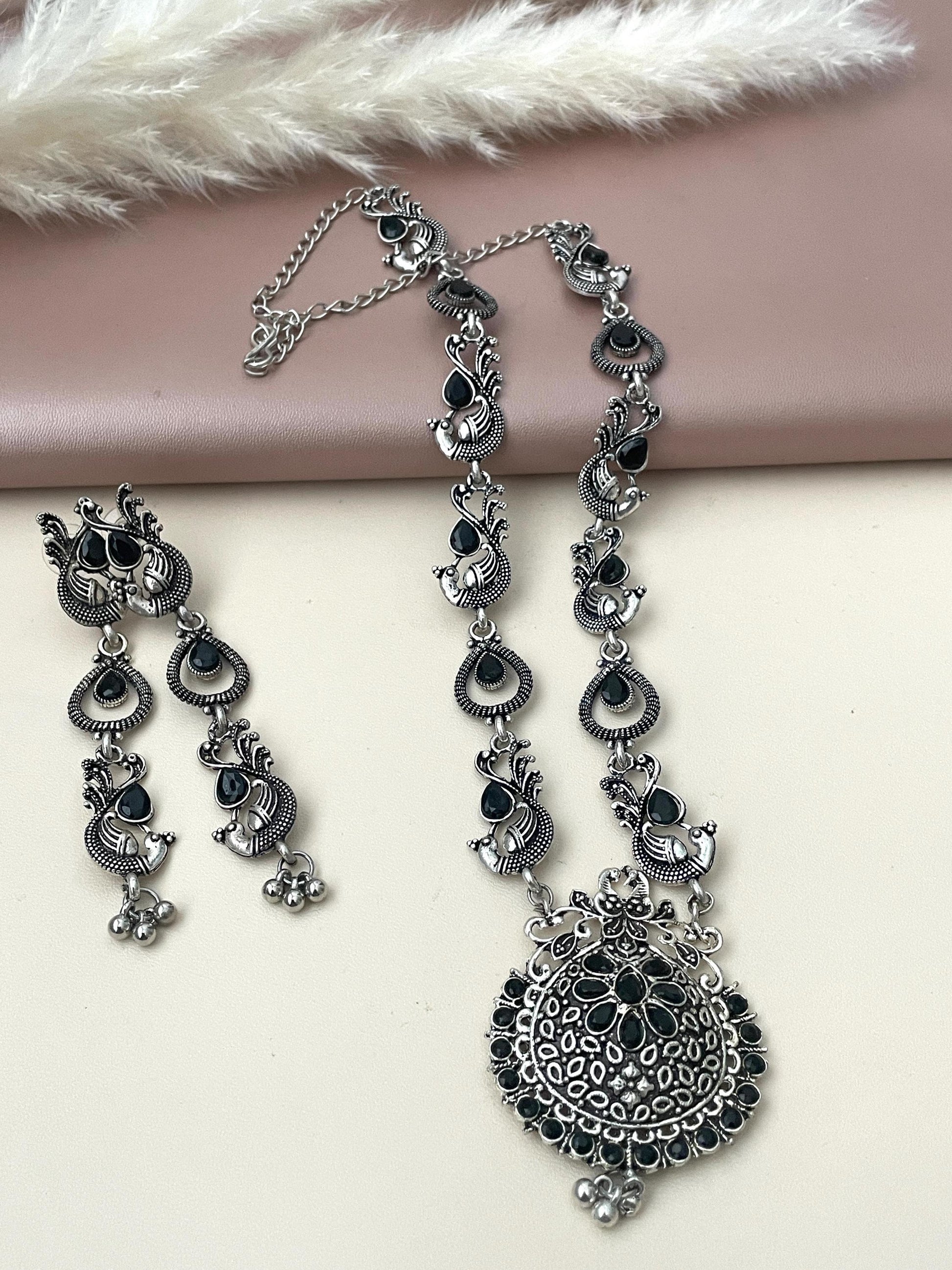 Long Oxidised black stone necklace set . This is high quality peacock themed set with black stones the long earrings are 3 inches long