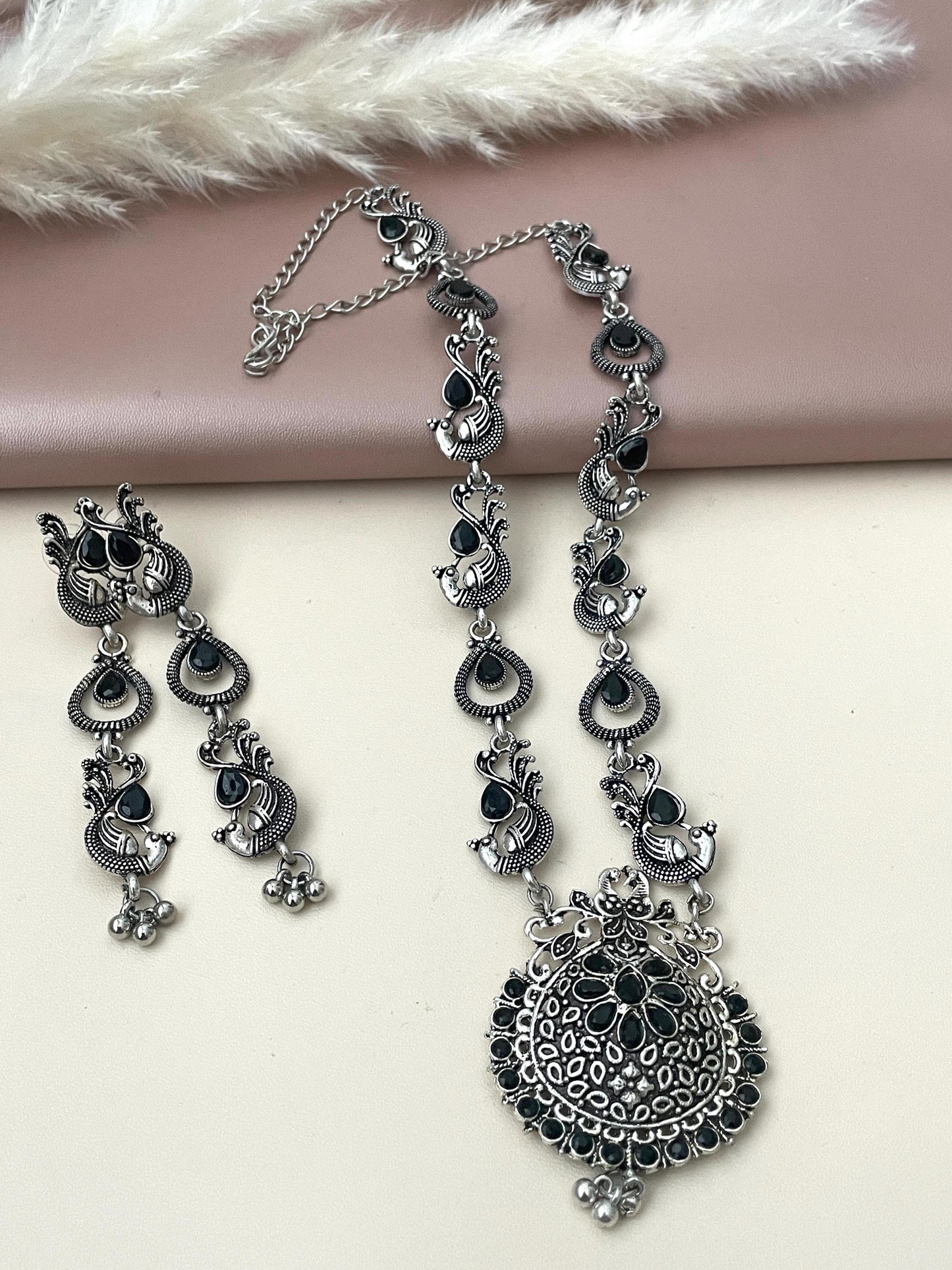 Long Oxidised black stone necklace set . This is high quality peacock themed set with black stones the long earrings are 3 inches long