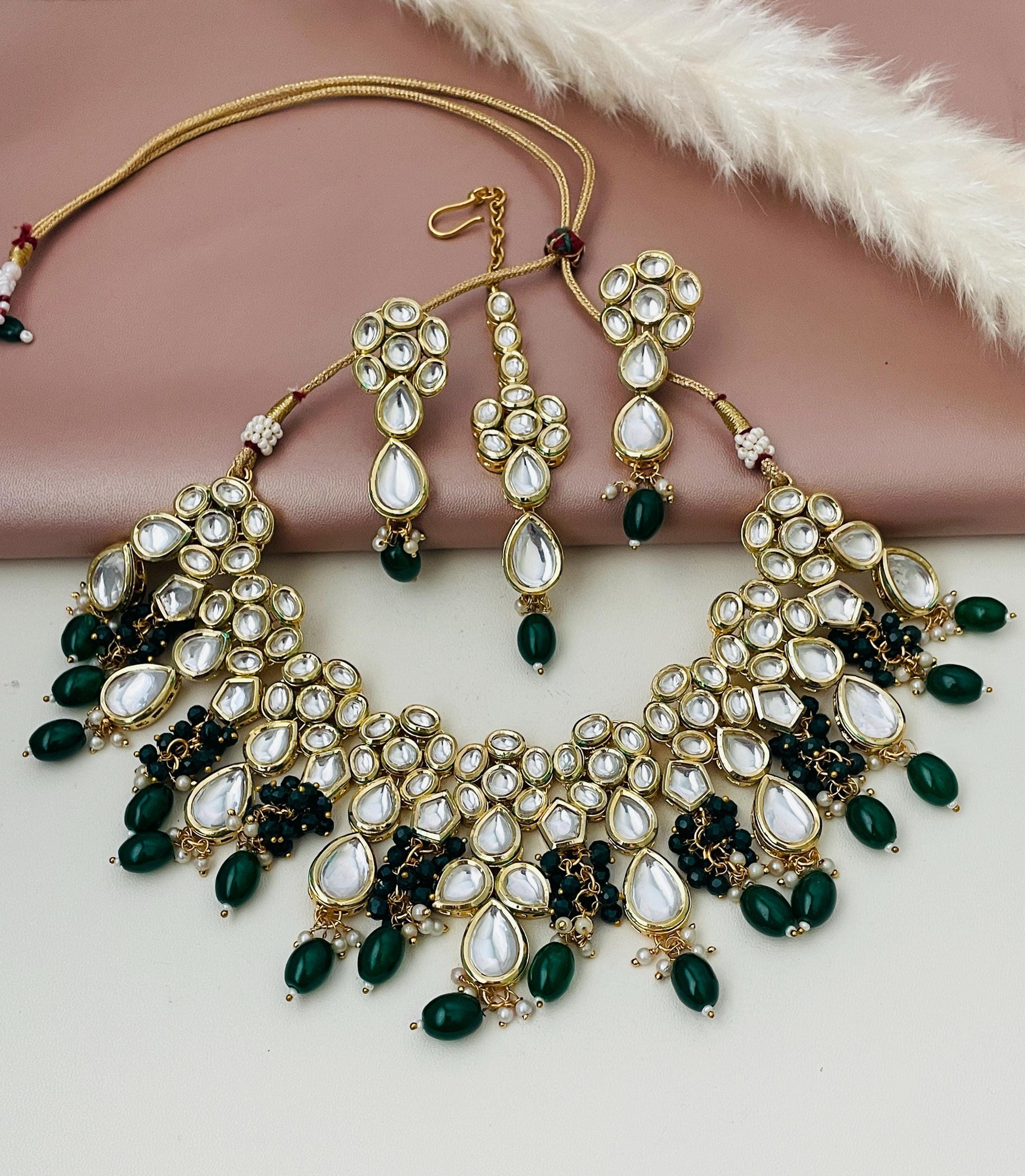 Dark green kundan necklace set with earrings and maang tika