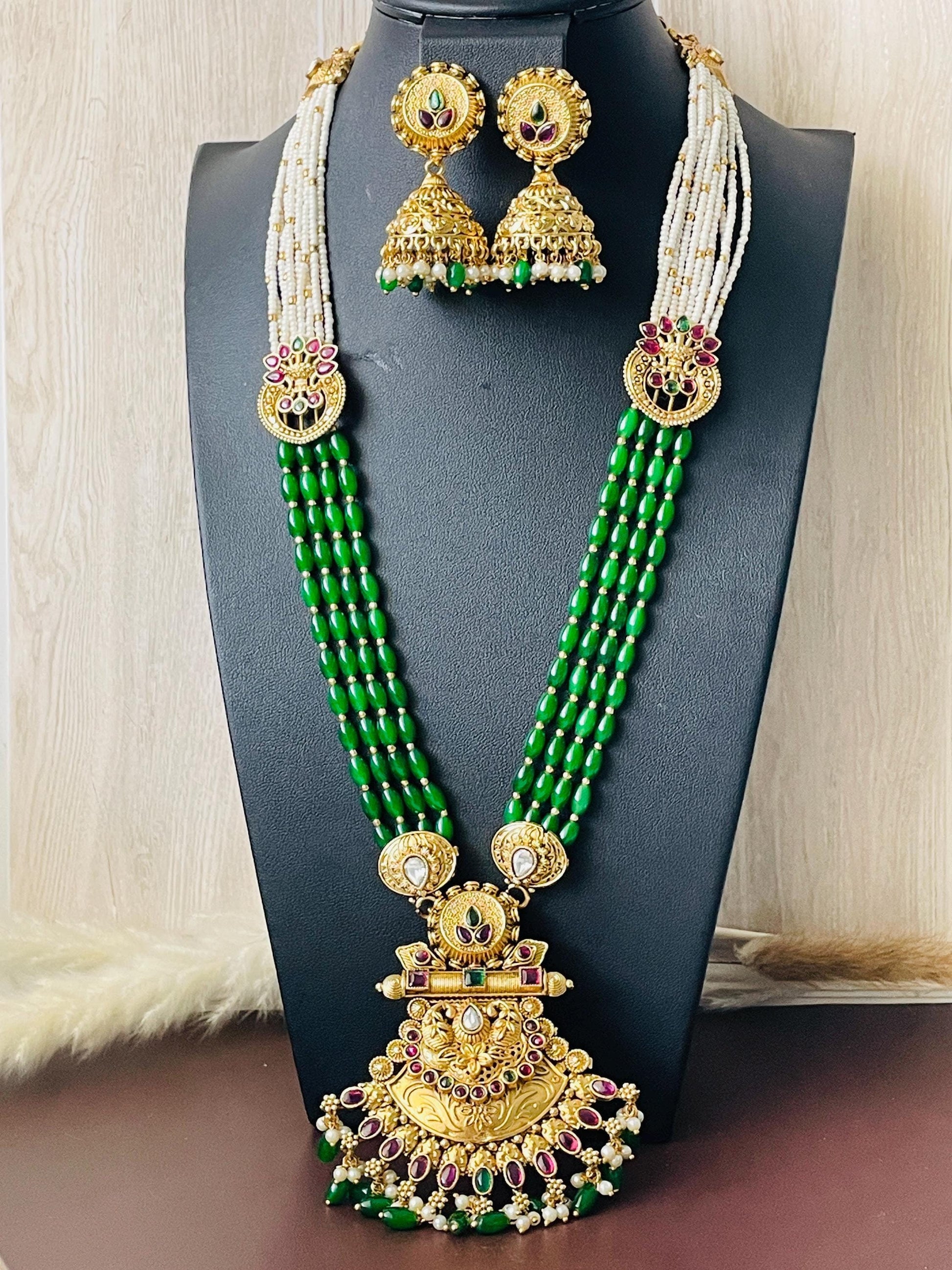 Gold platedkemp stonepearl green beads and big pendant  . 4 strands of green beads and pearls on each size . Pendant ia2.5 inch long