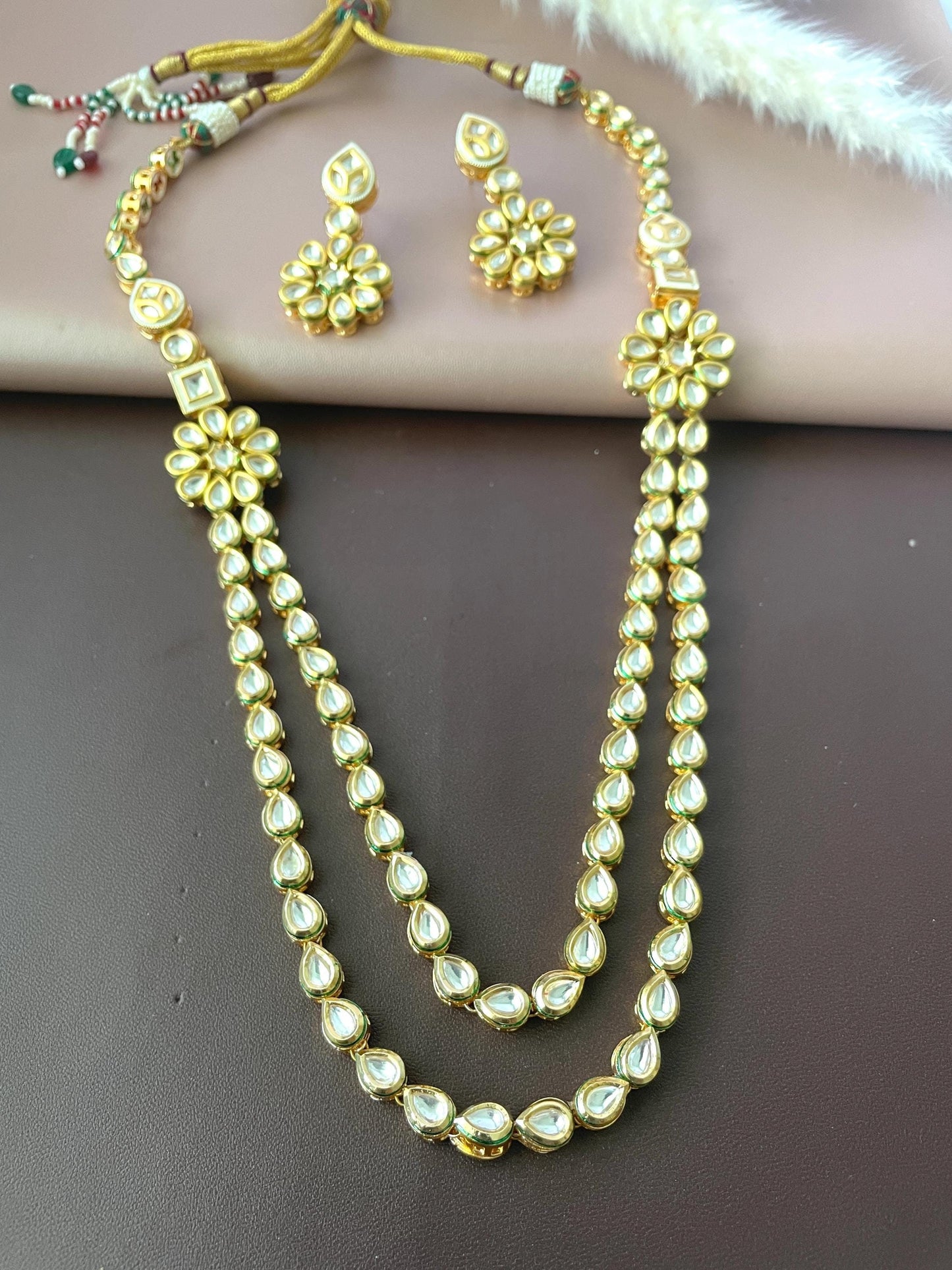 Long and short kundan necklace with earrings.Stunning quality. Very shiny high quality gems . Gold plated .