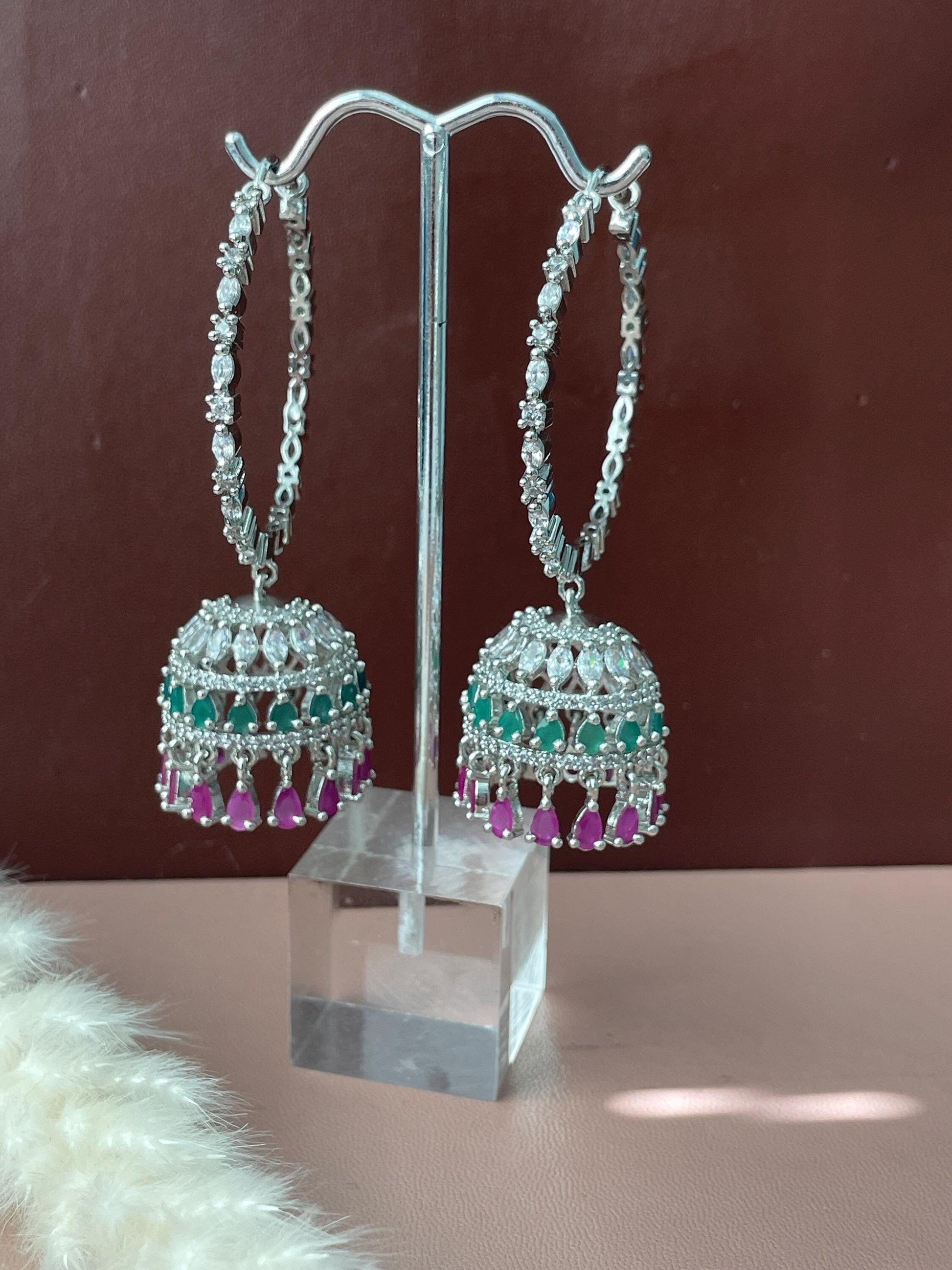 Green and magenta AD CZ jhumki hoops . These are high quality cubic zirconia hoops and jhumki dangle with green and magenta gems