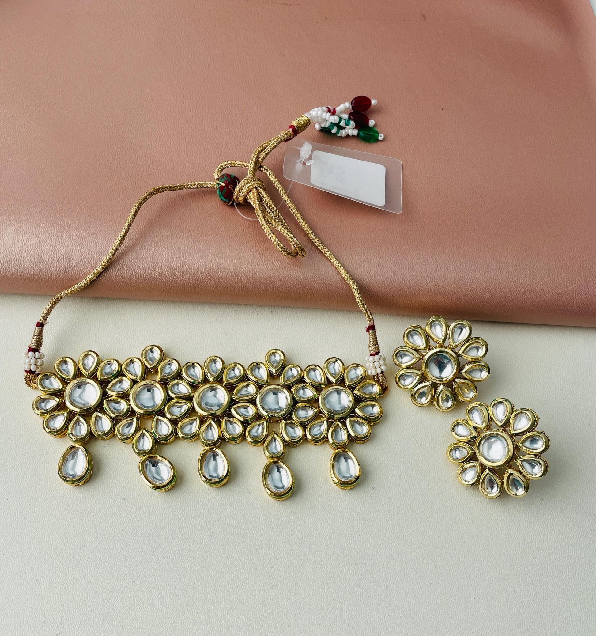 Kundan gold plated choker with matching earring . This big floral designis very unique and instead of dangles it comes with big flower studs
