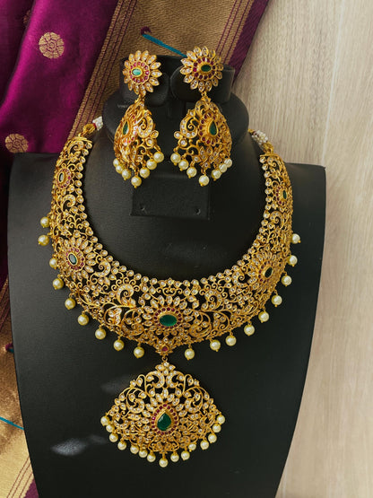 High quality CZ , pearl , Rubyand green gemstones make this necklace very stunning . Comes with matching earrings.Very intricate design perfect for that big day .