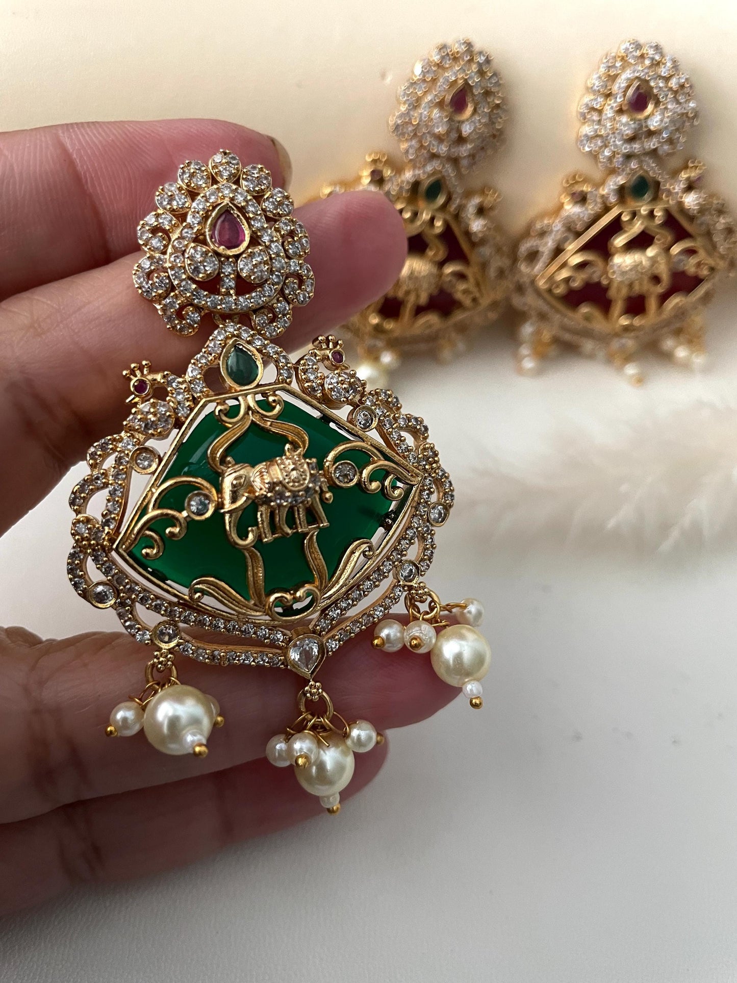 Premium quality Monalisa stone , kemp stone , CZ earring.3.15 inches long with very intricate design with peacock and elephant motif .Matte gold plated and very classy !