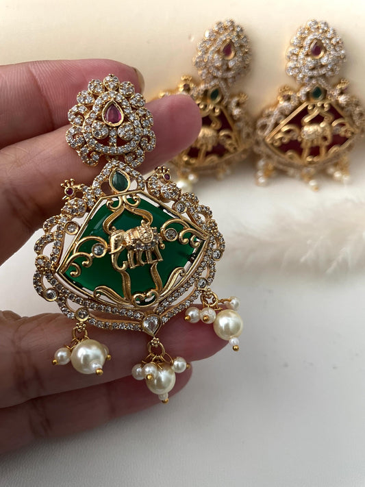Premium quality Monalisa stone , kemp stone , CZ earring.3.15 inches long with very intricate design with peacock and elephant motif .Matte gold plated and very classy !