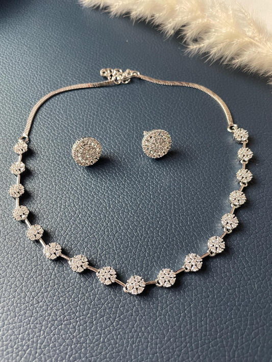 High quality rhodium plated CZ necklace with stunning earrings. The flower shaped CZ motif in silver plated chain . Very delicate looking and so classy .