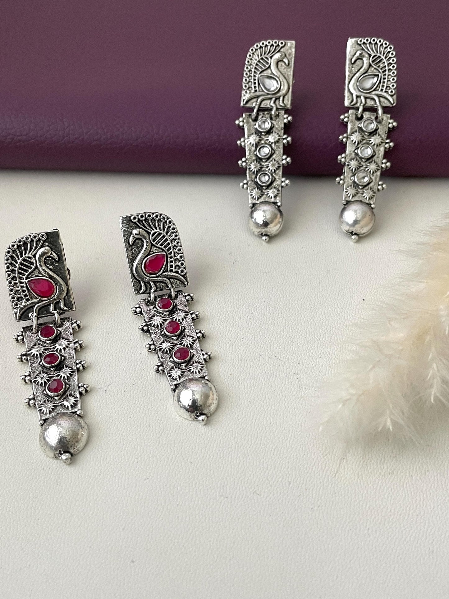 High quality silver lookalike peacock motif Oxidised earrings . Two option available Ruby and  white stones . Very lightweight.