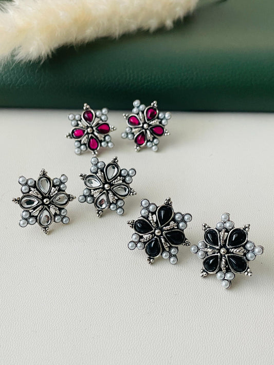 Small high quality Oxidised studs in pearl setting .3 colors available. Ruby, white and black . These flower shaped earrings are very lightweight and almost silver looking .