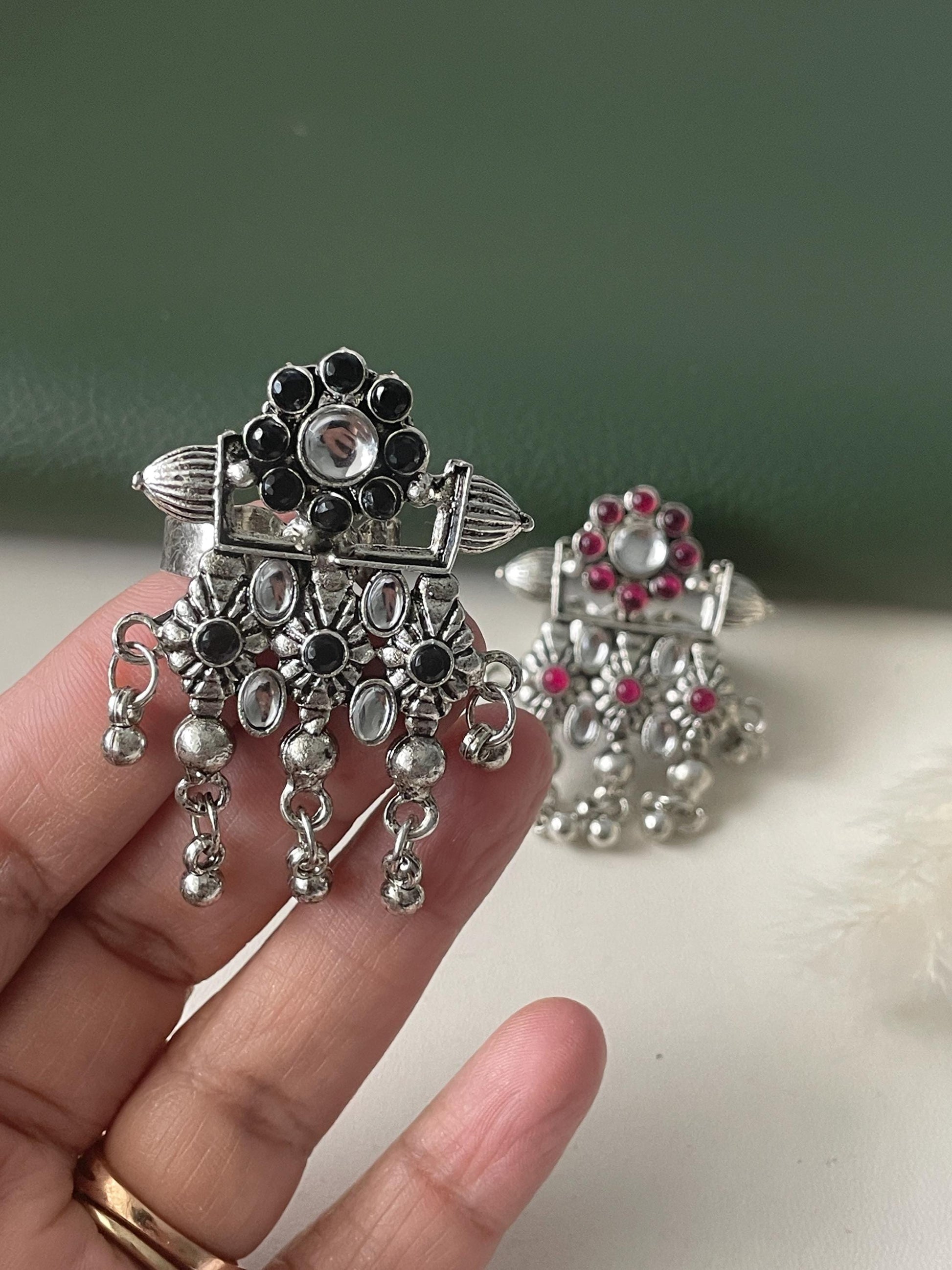 High quality Oxidised finger ring available in two colors . Ruby and black . Unique design and adjustable.