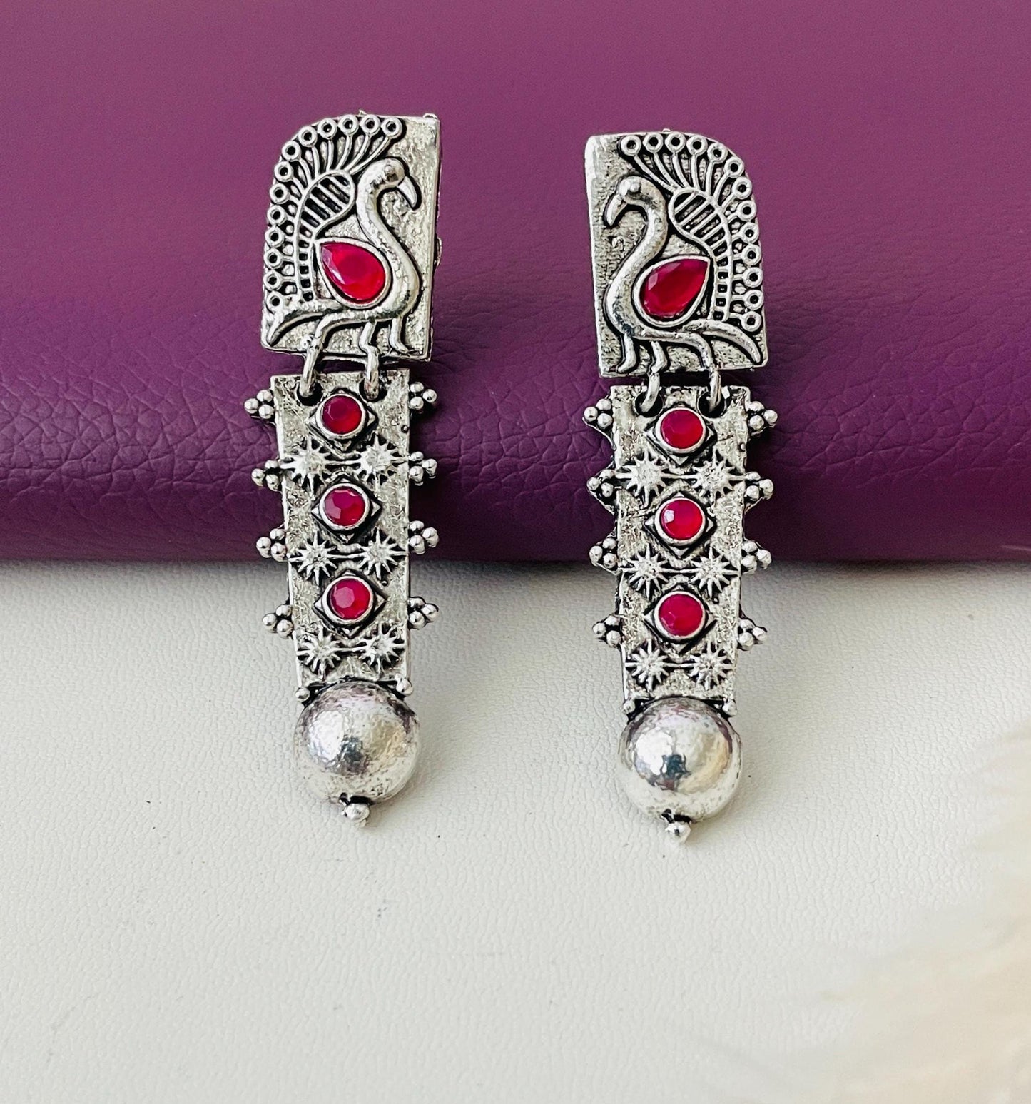 Silver lookalike peacock Oxidised earrings in Ruby and white