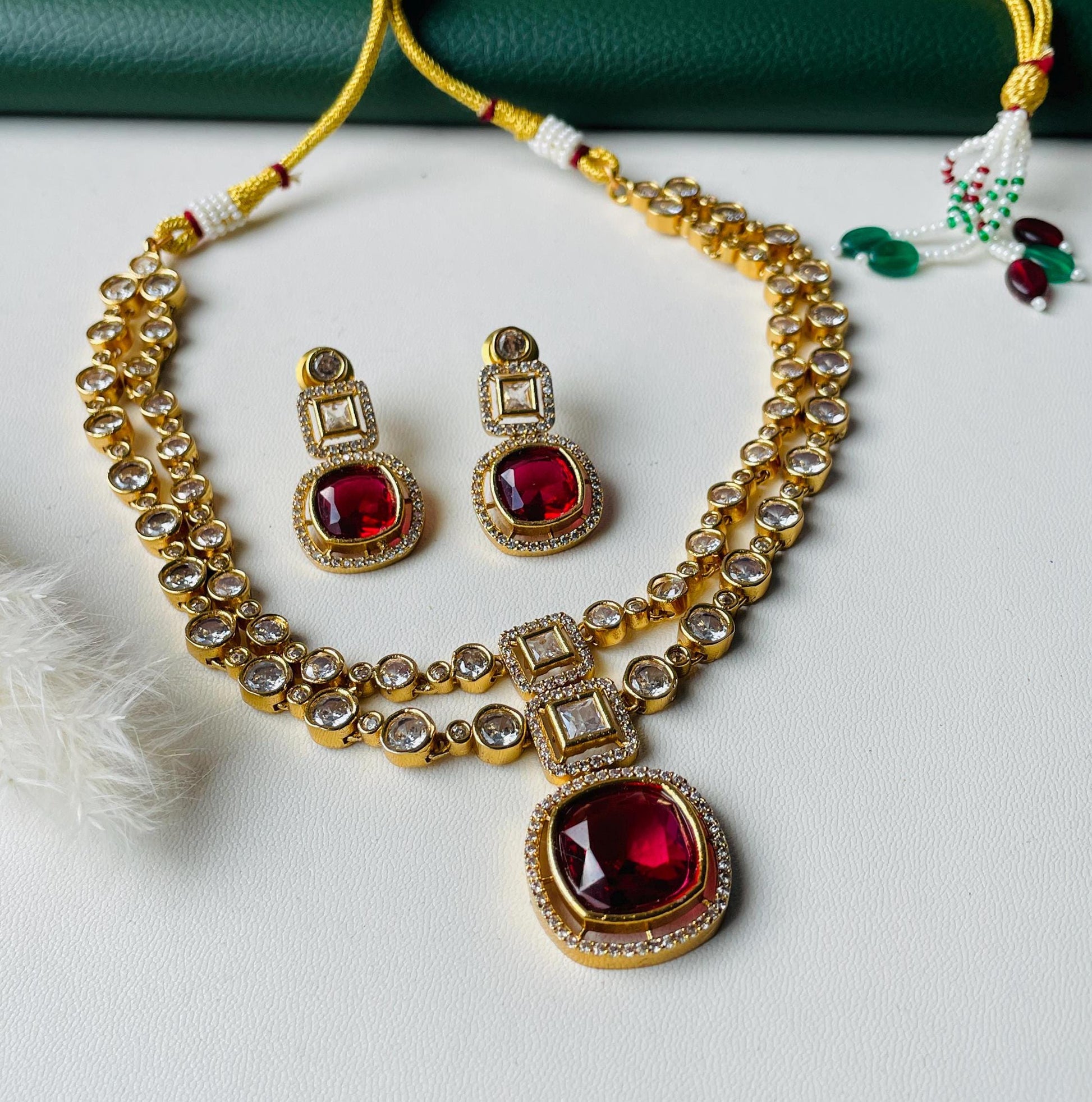 Kundan and Ruby gold plated two layered stunning neckpiece with matching earrings . Great for wedding or party .