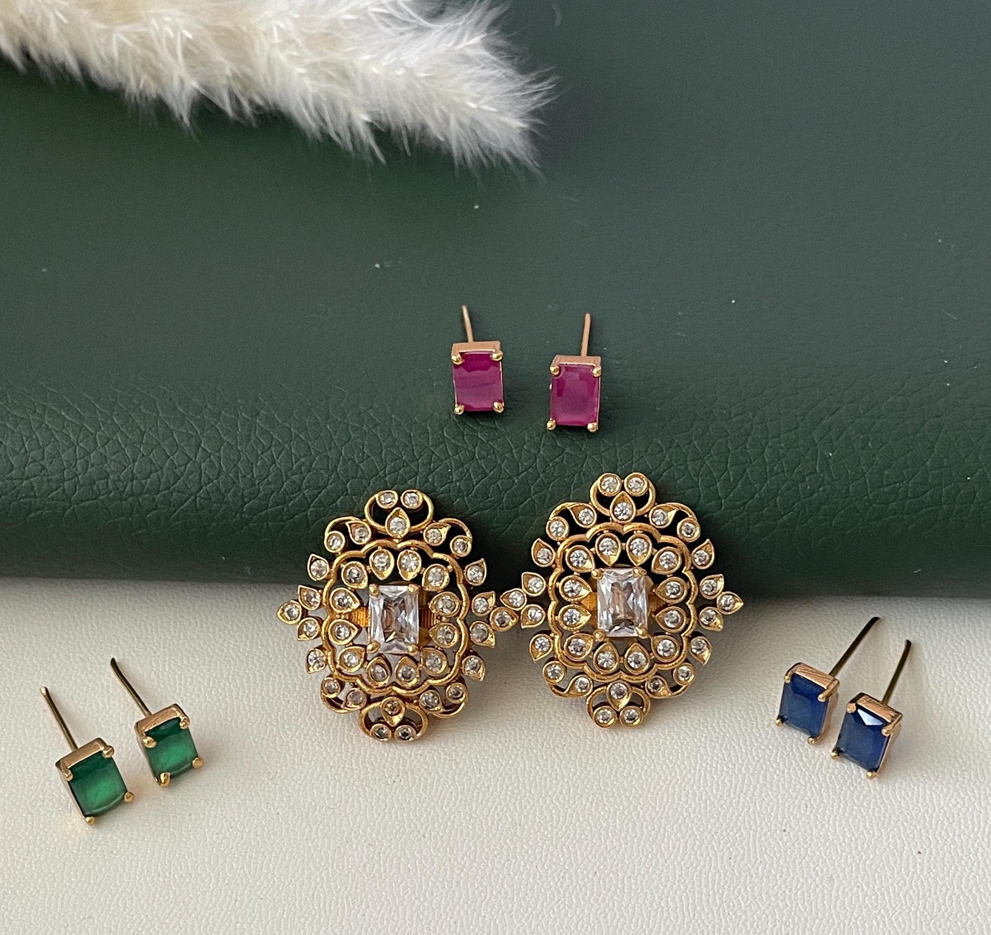 High quality kemp stone and cubic zirconia earrings with changeable color stones .Red , blue green and white earrings in one .