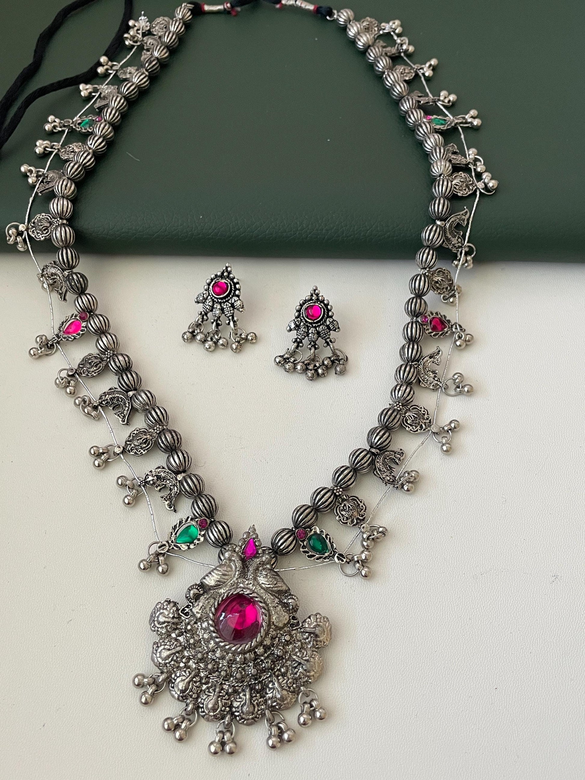 Oxidised kolhapuri saaj With matching earrings . This is tmore like black than shiny Oxidised set . 24 inch long with traditional motif like masali ( fish ), paan ( leaf)