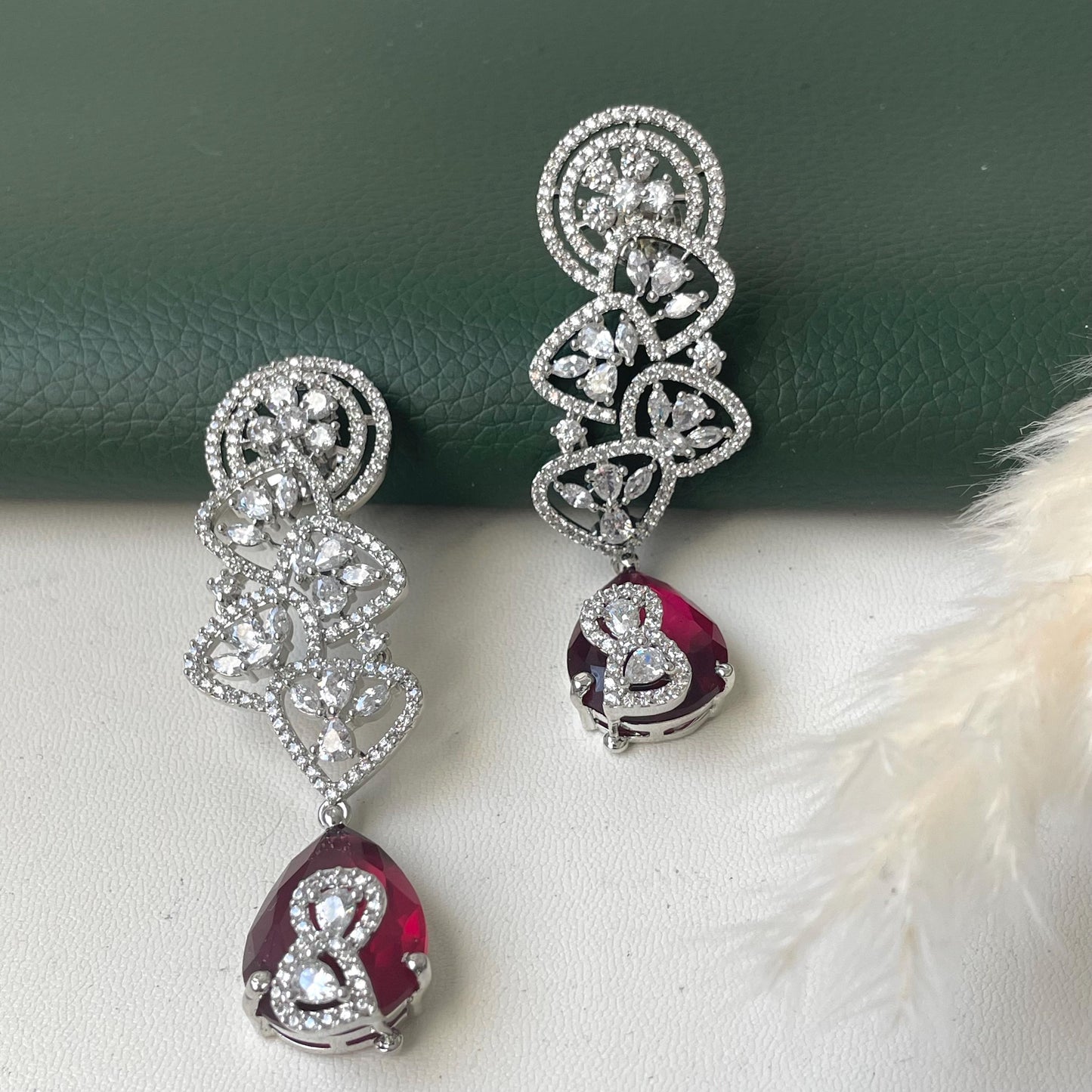 Rhodium plated cubic zirconia and Ruby earrings. Moden design and 3.5 inches long . Stunning high quality piece .