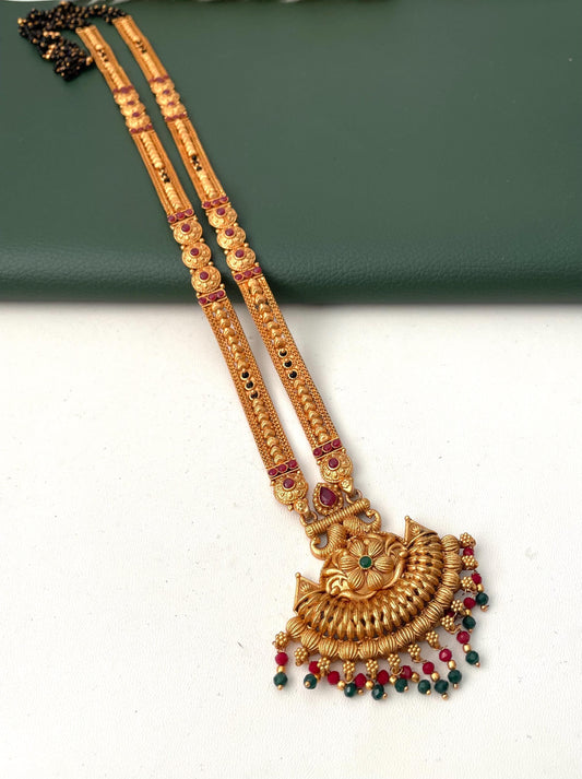 Long high gold plated mangalsutra  with green and Ruby beads. Easy to wear and perfect for saree