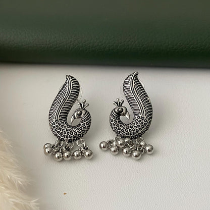 Oxidized earrings in peacock motifs.