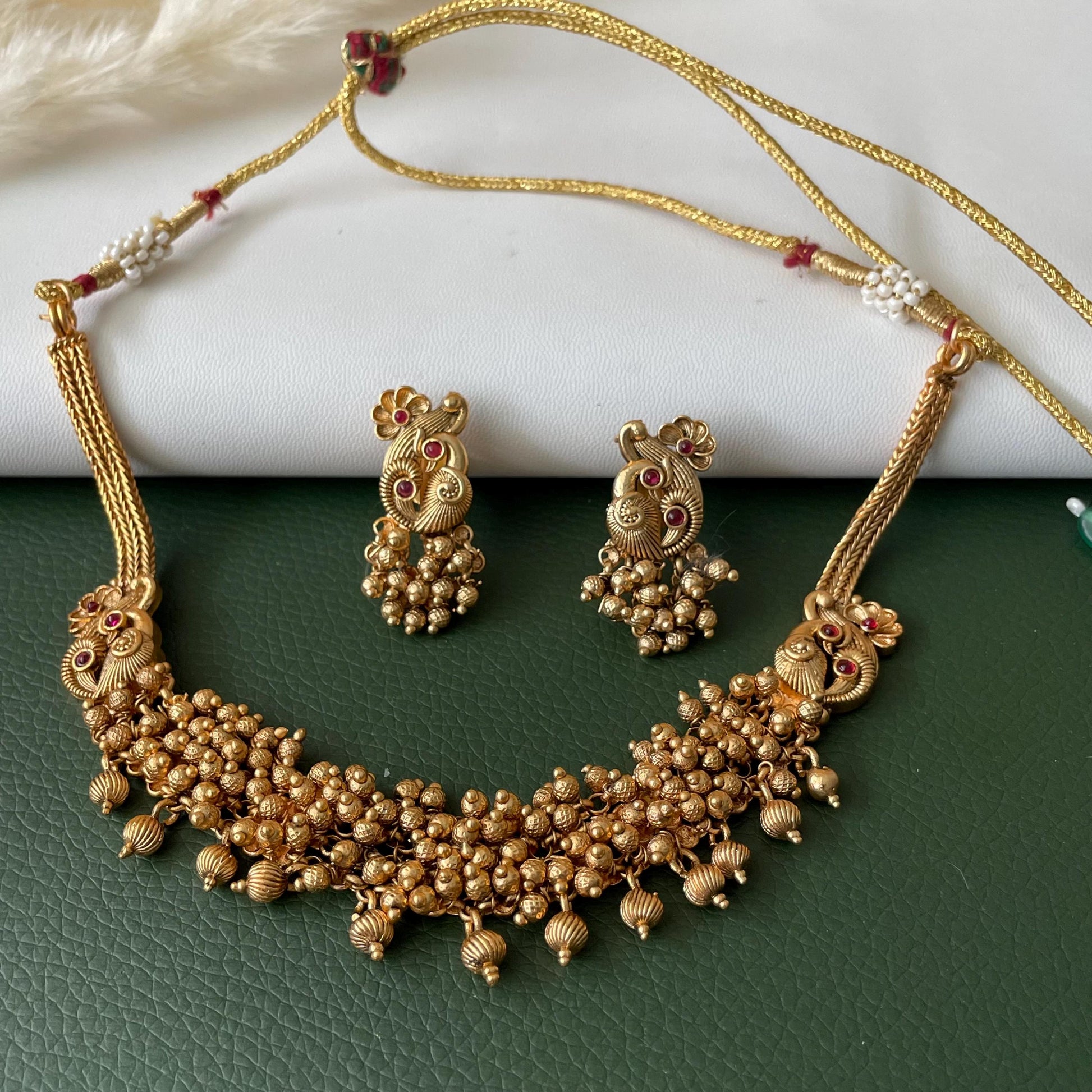Short gold plated ghungaroo necklace set with peacock earrings