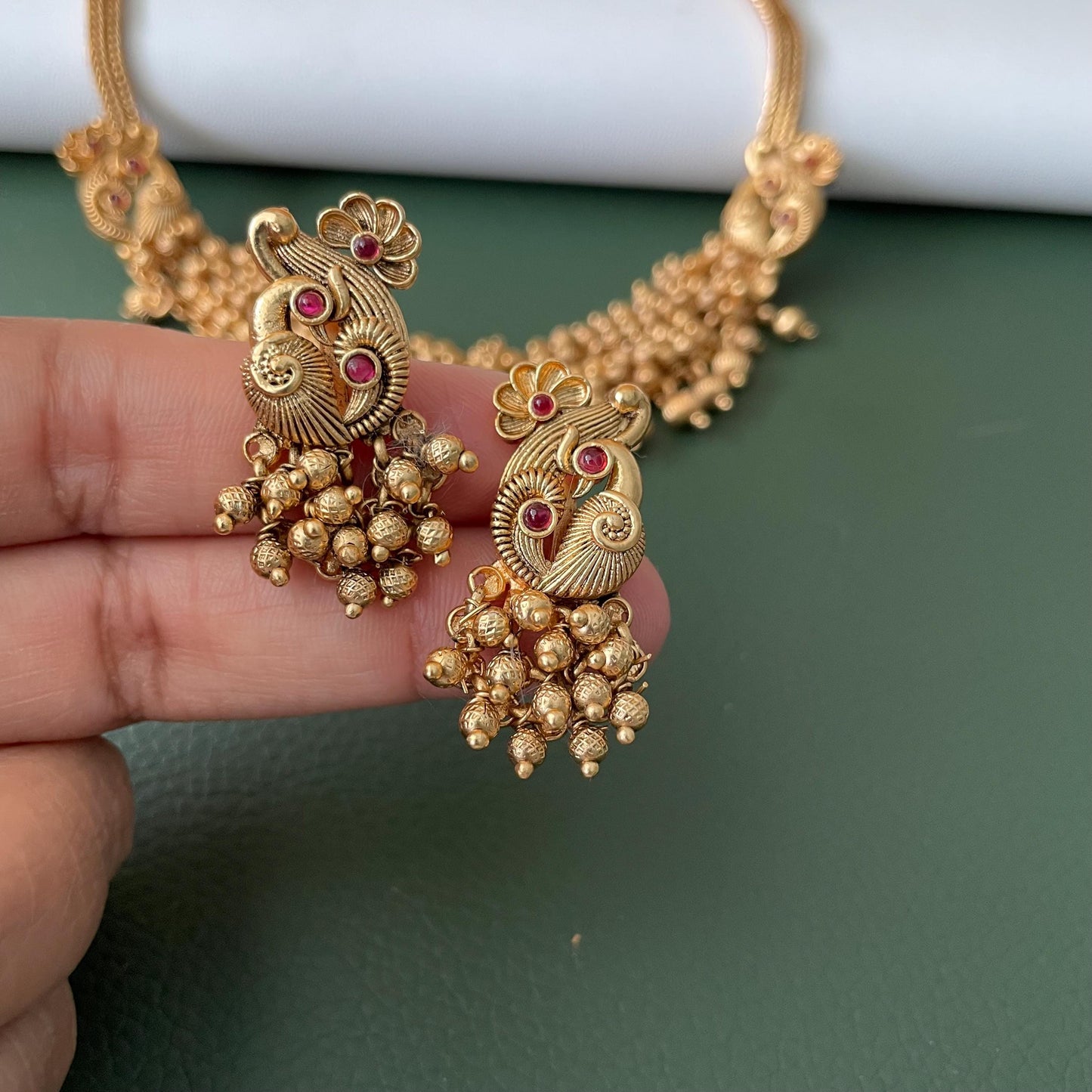 Short gold plated ghungaroo necklace set with peacock earrings