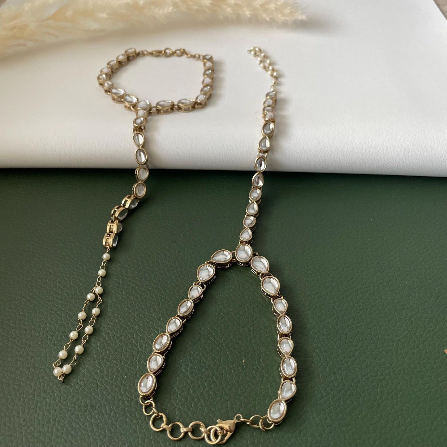 Antique gold colored kundan and pearl haath panja