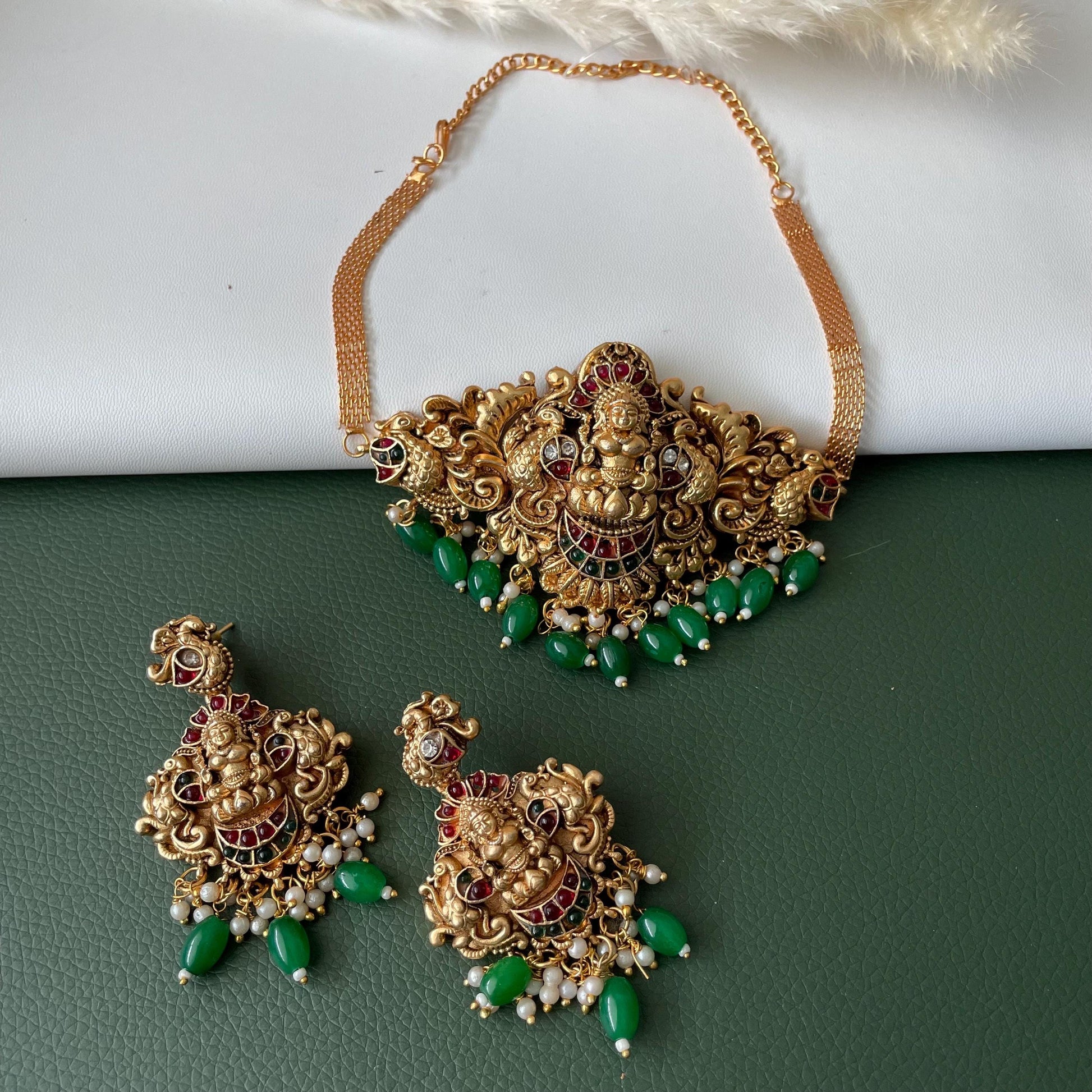 antique gold plated Lakshmi pendent choker with matching earrings . Stunning temple jewelry with kemp stones and green beads