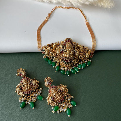 antique gold plated Lakshmi pendent choker with matching earrings . Stunning temple jewelry with kemp stones and green beads