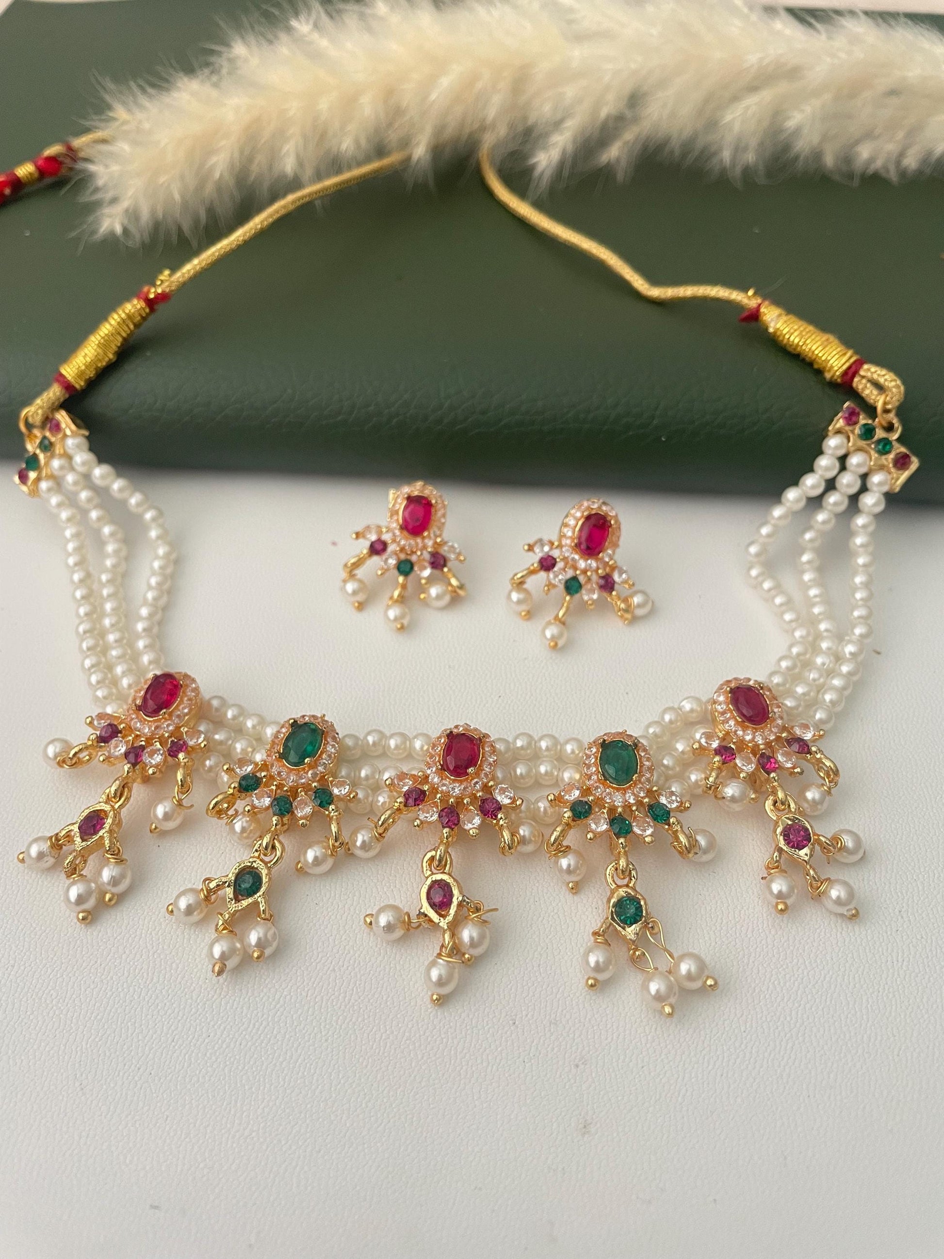 Maharashtraian Chinchapeti in fancy mode. The traditional pearl and colored beads weaved to make a choker and comes with matching earrings. adjustable dori makes it easy to wear