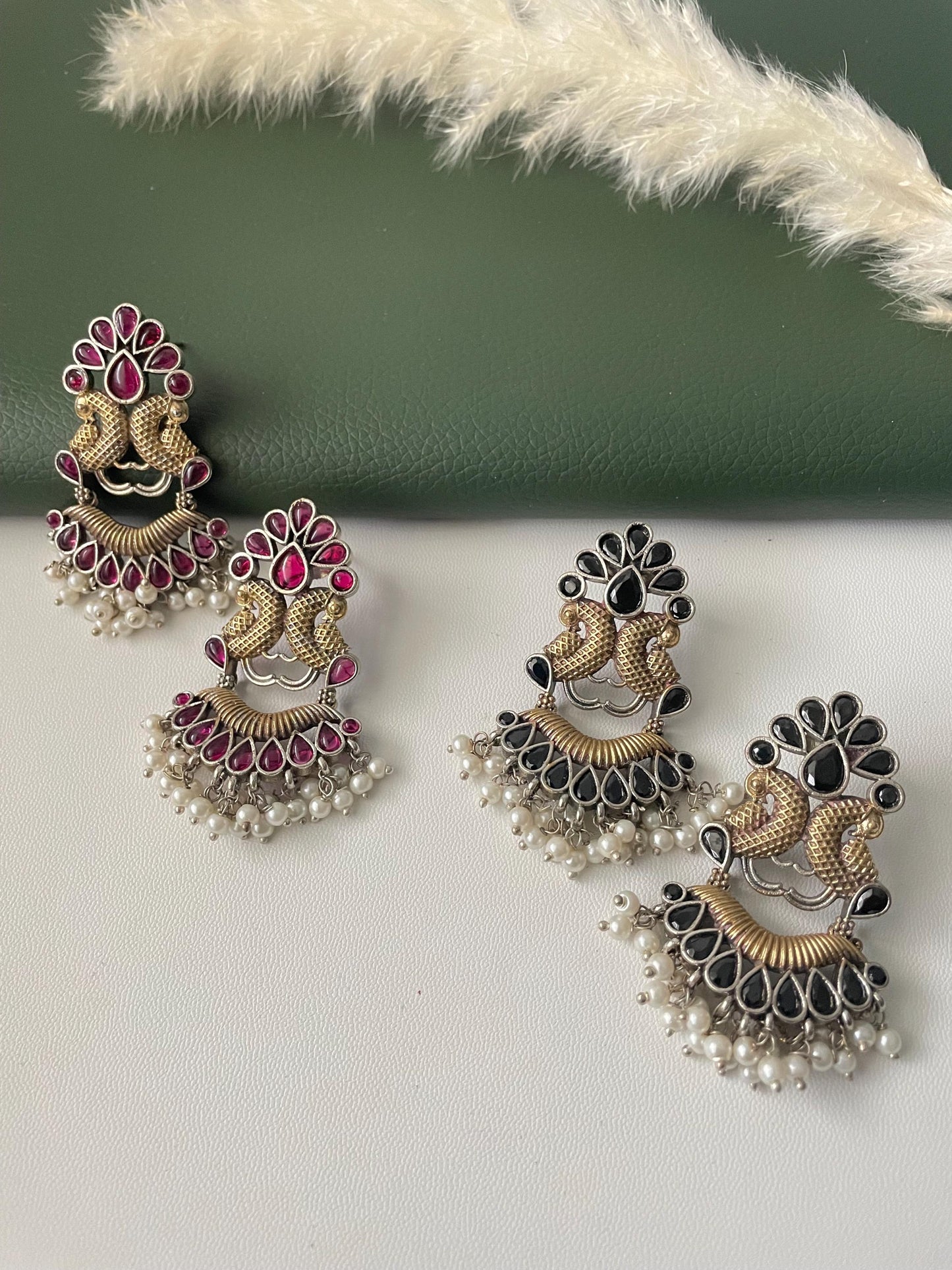 Oxidised dual tone peacock motif earrings