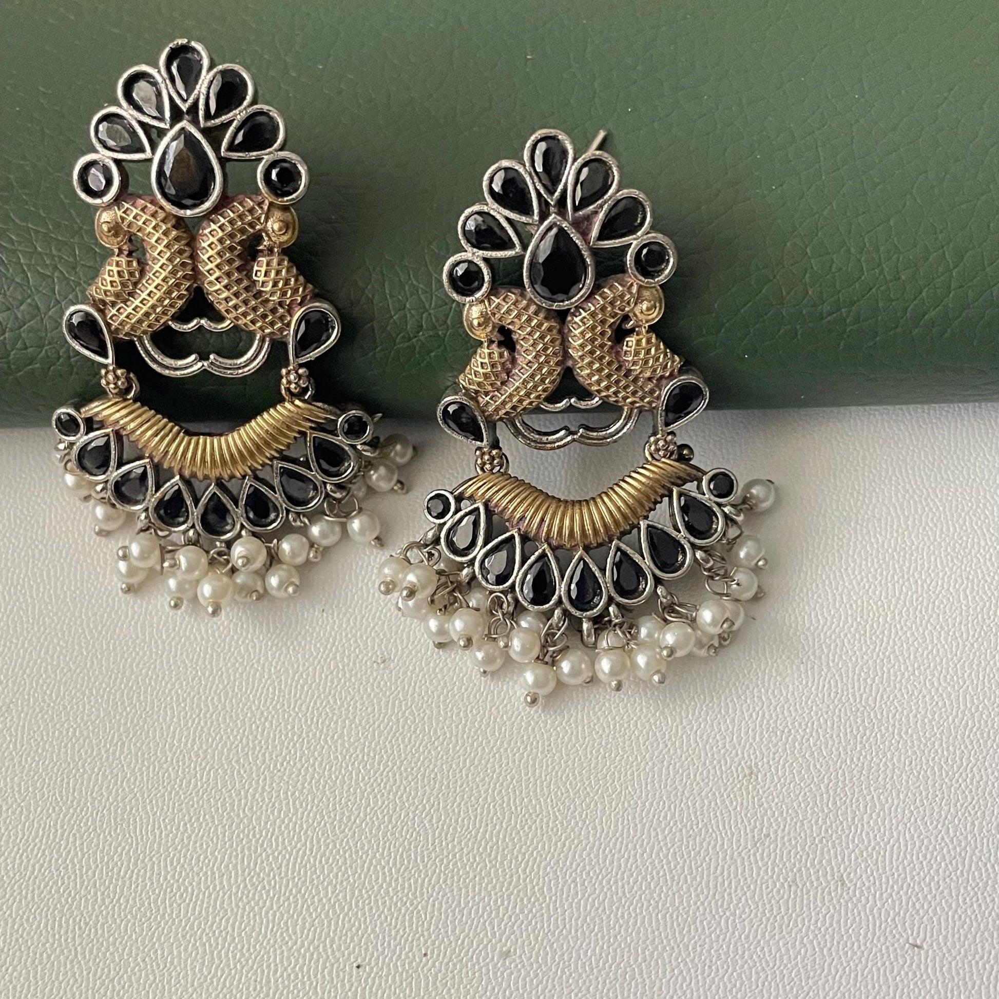 Oxidised dual tone peacock motif earrings