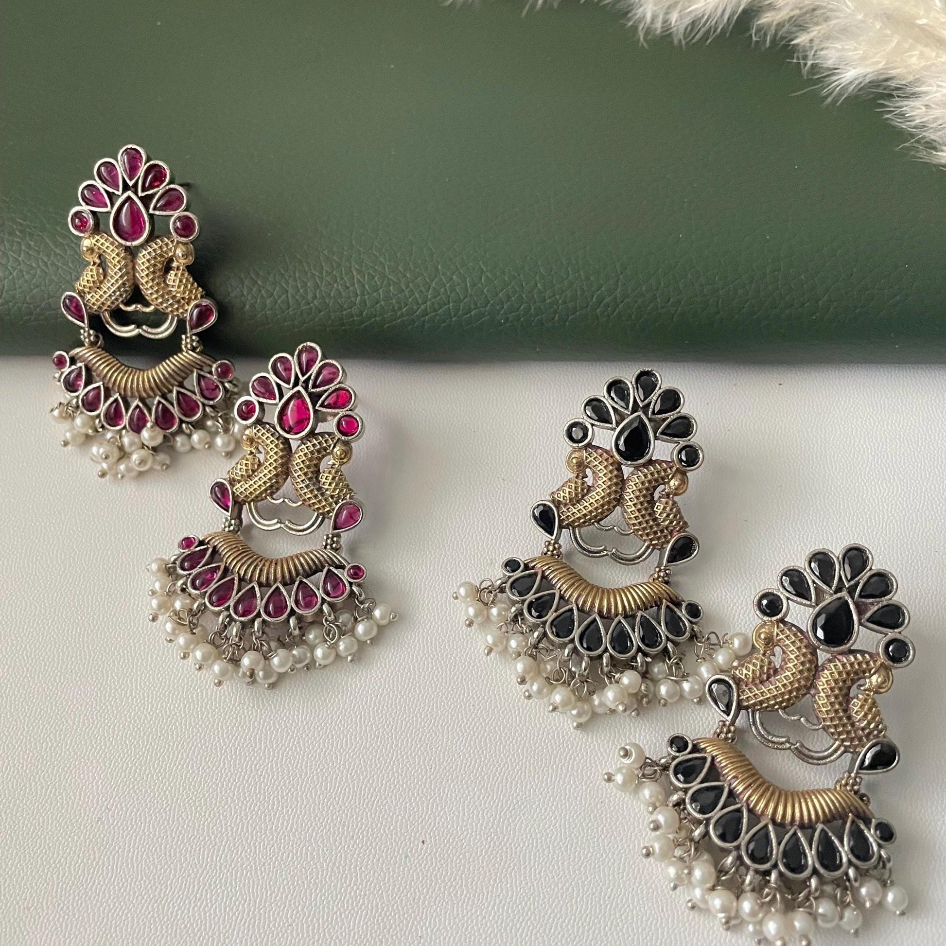 Oxidised dual tone peacock motif earrings