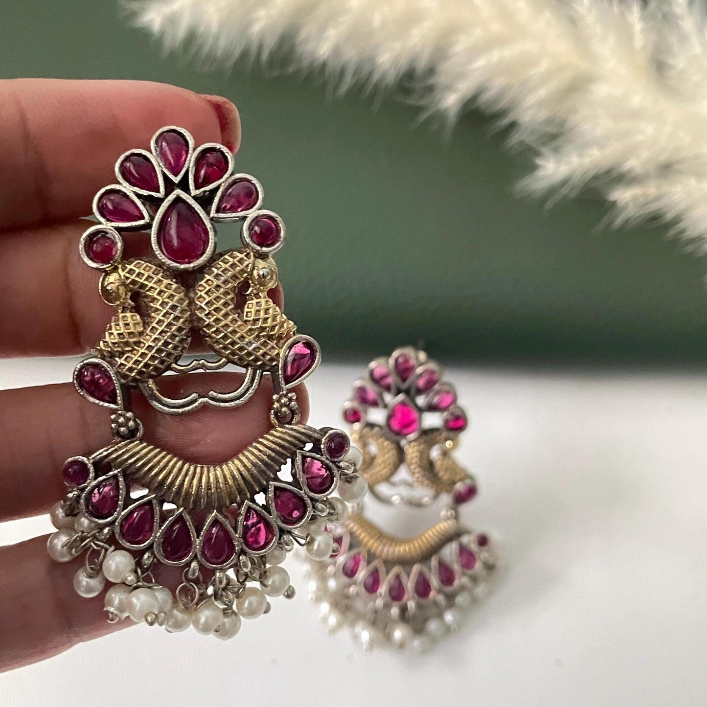 Oxidised dual tone peacock motif earrings