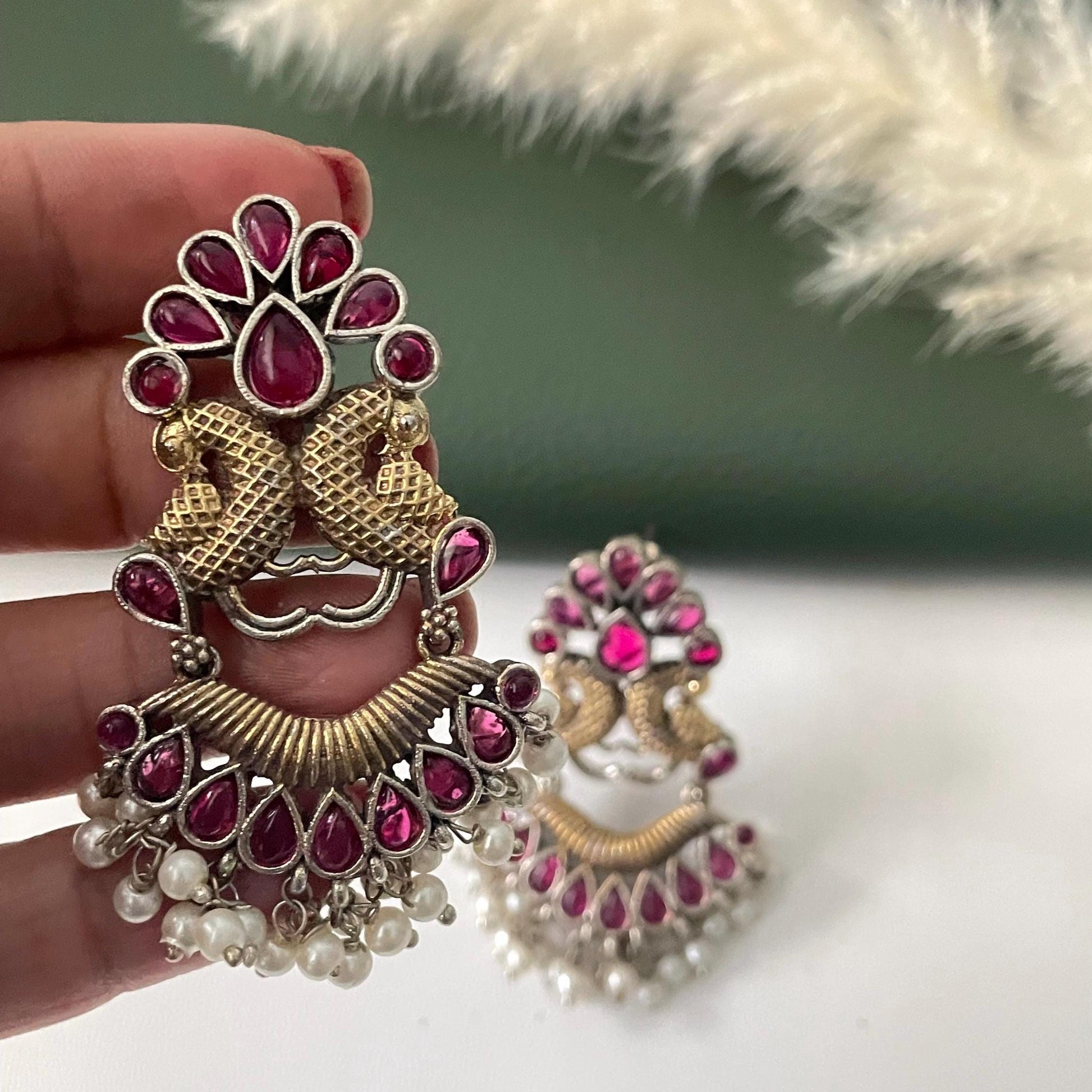 Oxidised dual tone peacock motif earrings