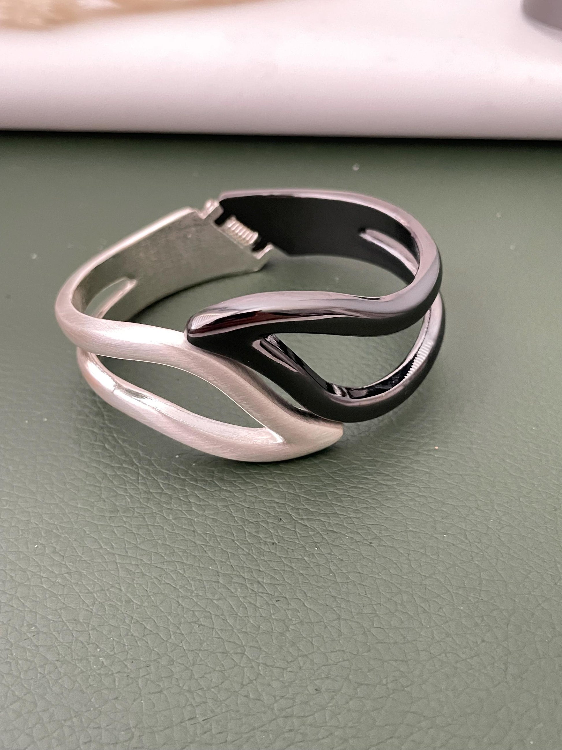 Silver and black fancy cuff bracelets
